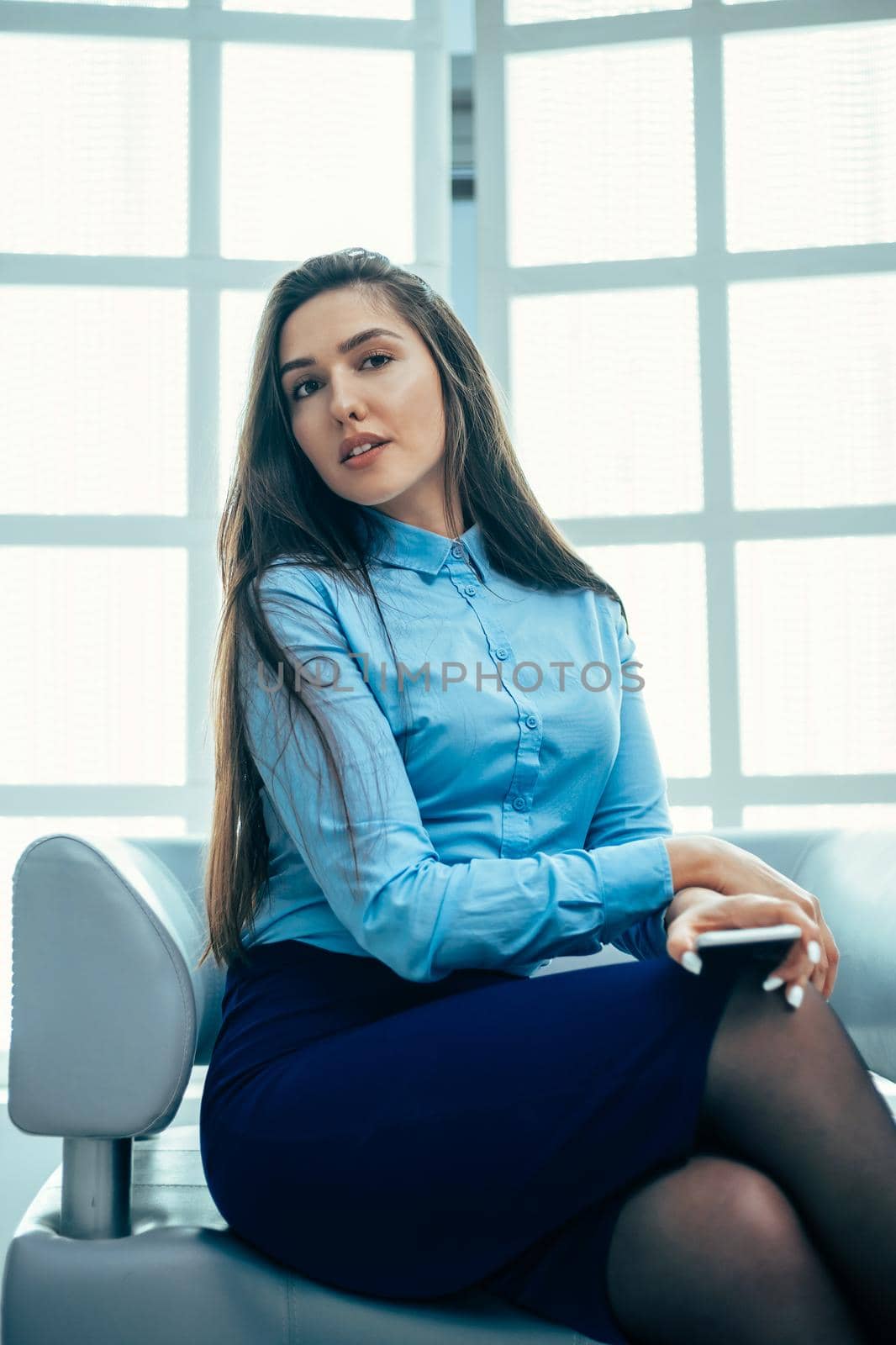 close up. successful young business woman sitting in the office lobby