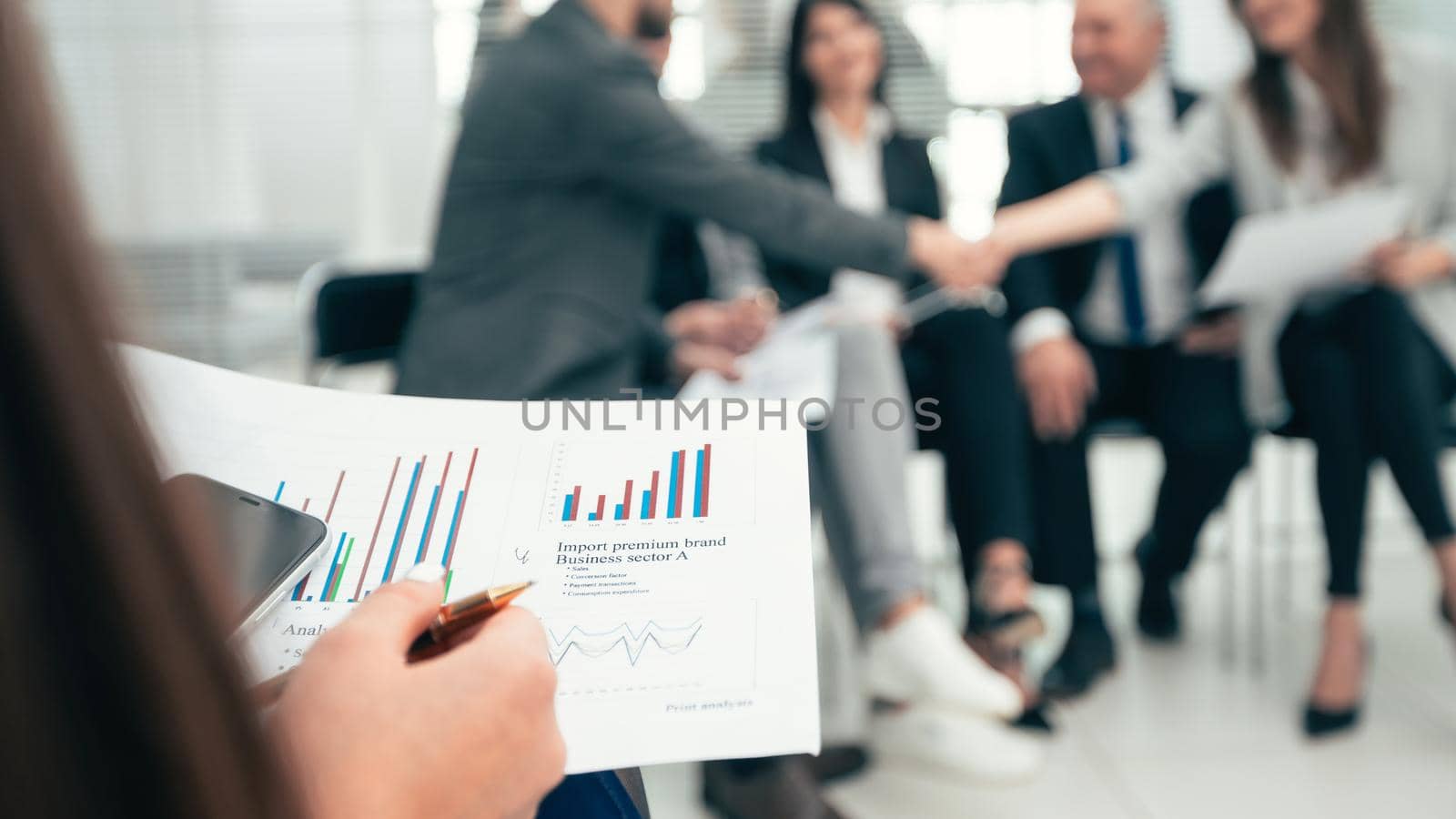 close up. businesswoman with a financial report at a working meeting with the business team. business concept