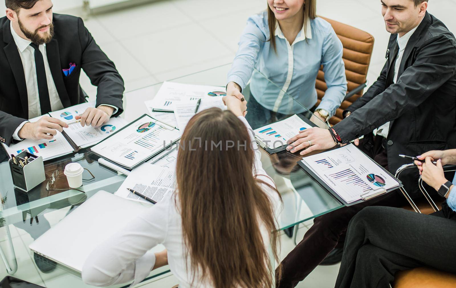 the handshake business partners after discussing the terms of a new contract in the workplace in a modern office