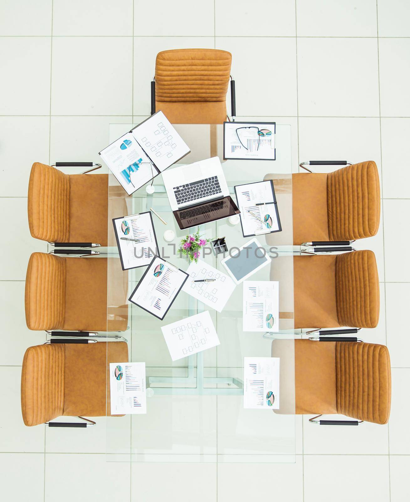 top view - financial charts,marketing charts,notebooks and pens at the work place in an empty office .the photo is a blank space for your text