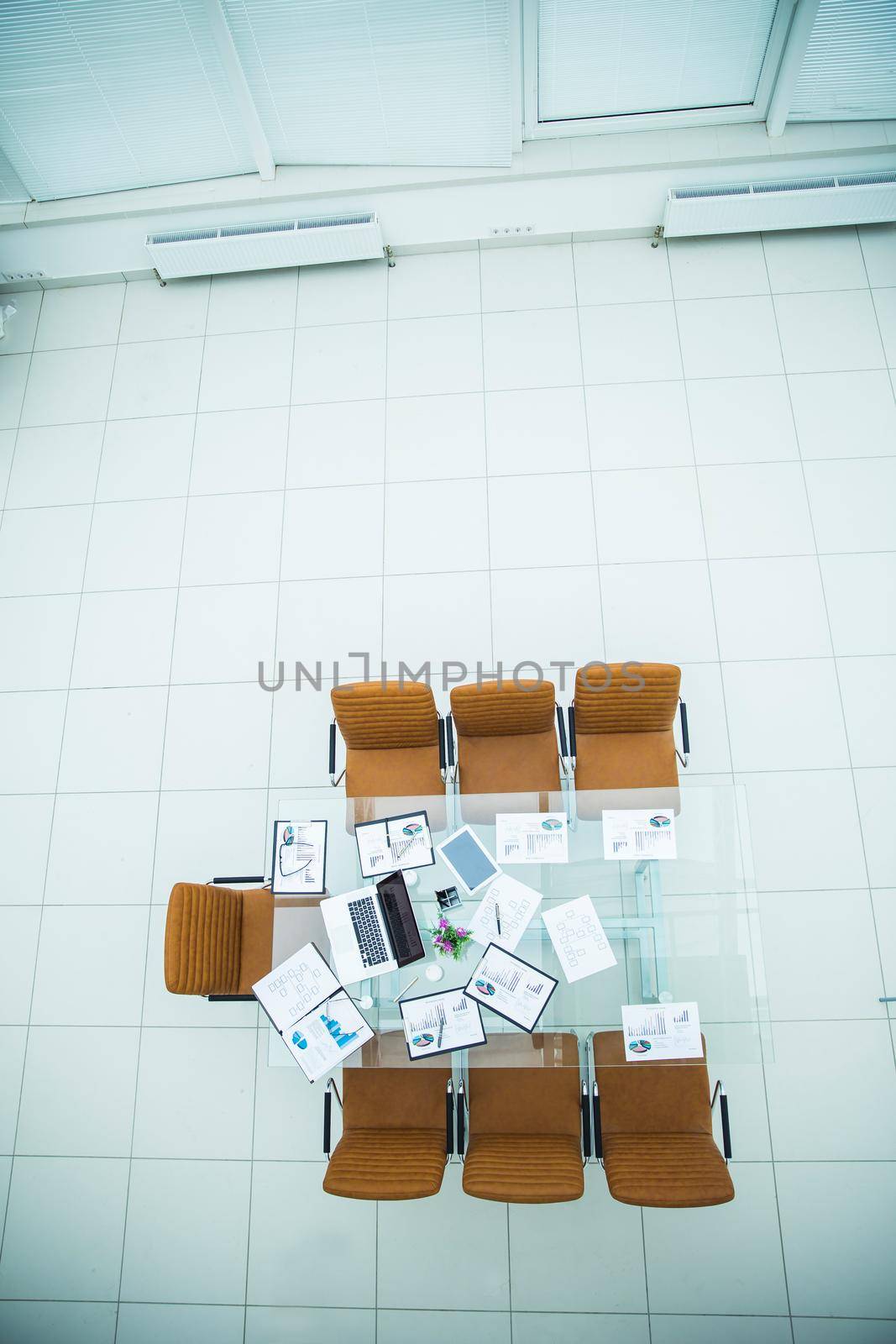 top view - financial charts,marketing charts,notebooks and pens at the work place in an empty office .the photo is a blank space for your text