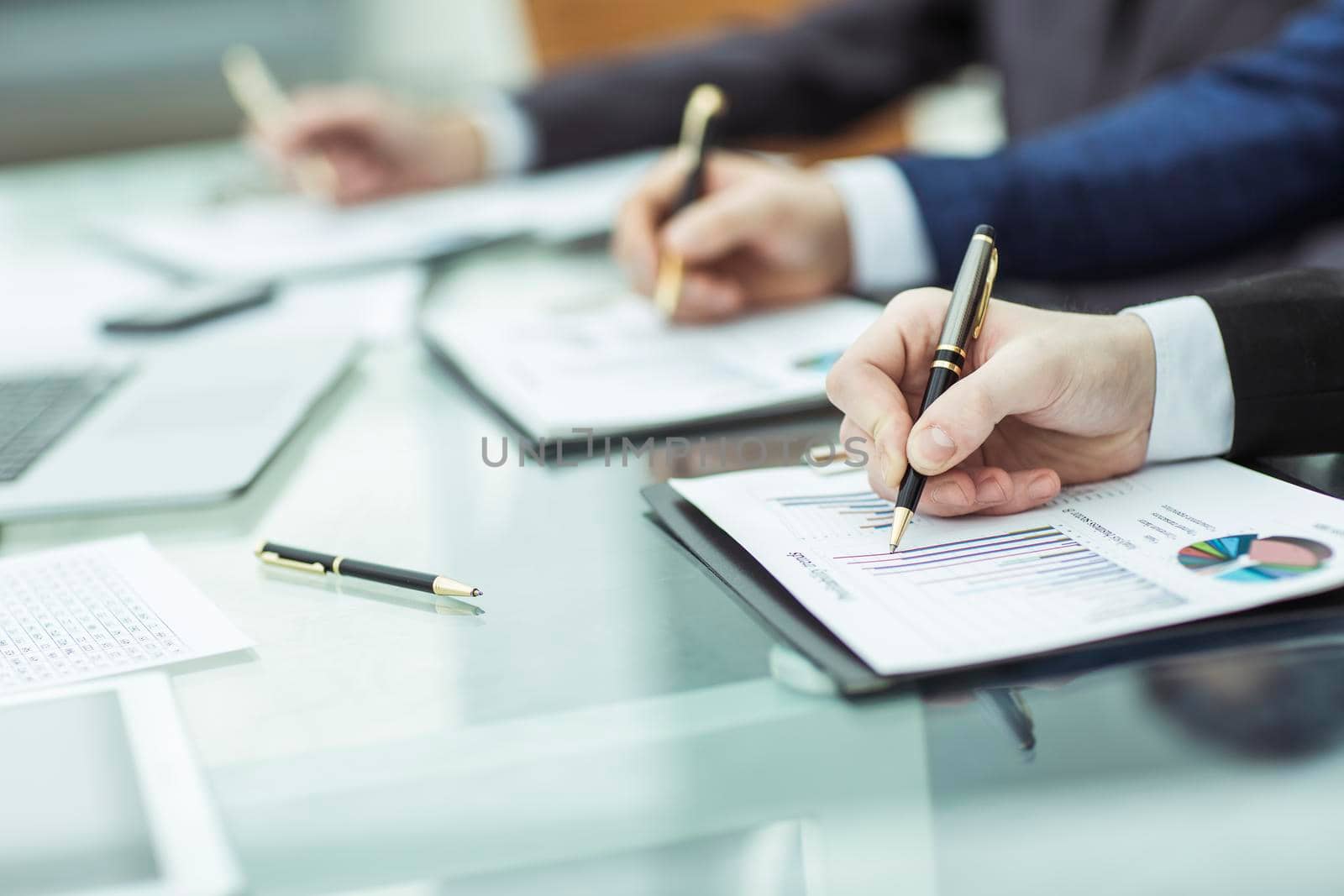 closeup of business team is working with financial charts.the photo has a empty space for your text
