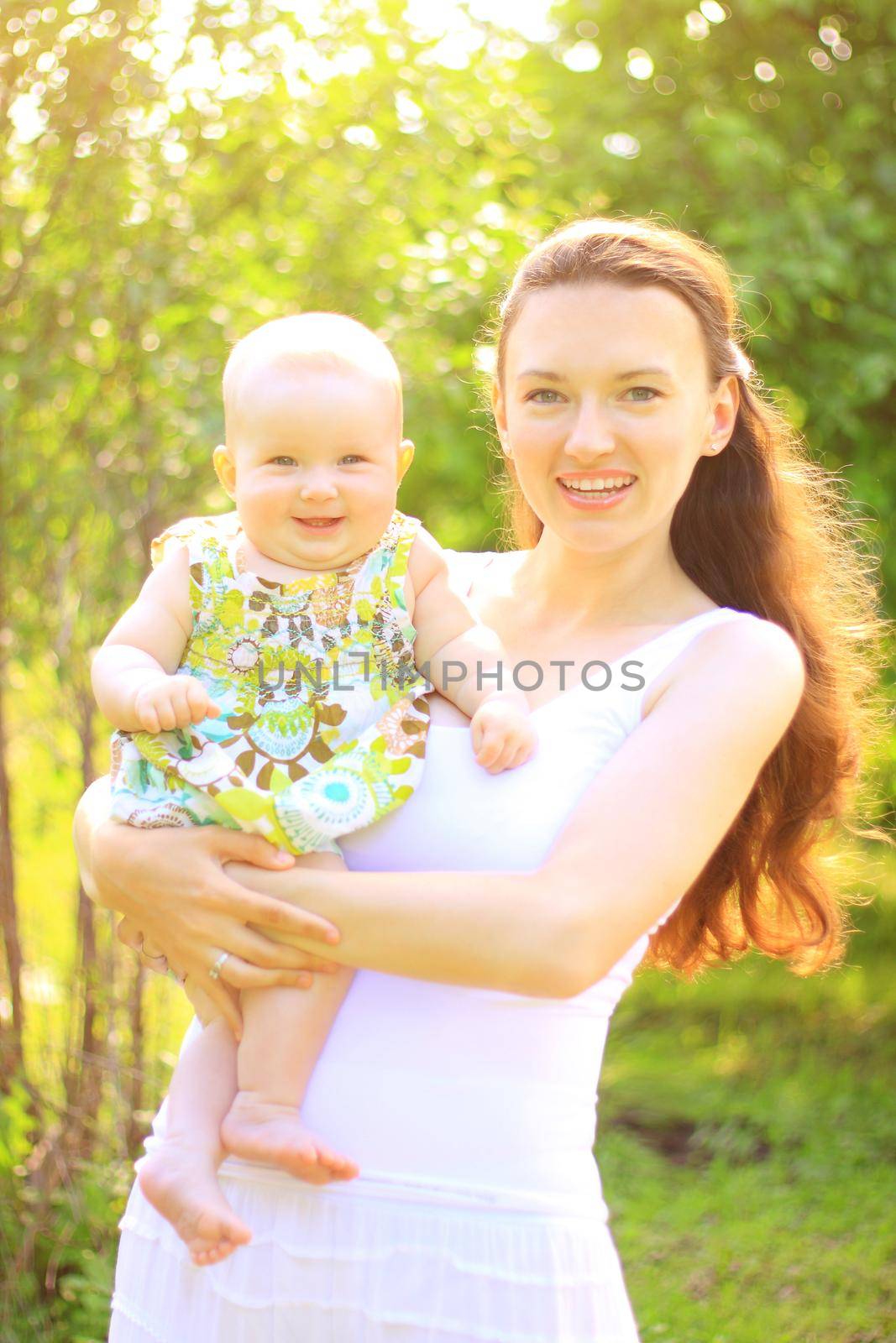 Beautiful Mother And Baby outdoors. Nature. Beauty Mum her Child playing in Park together by SmartPhotoLab