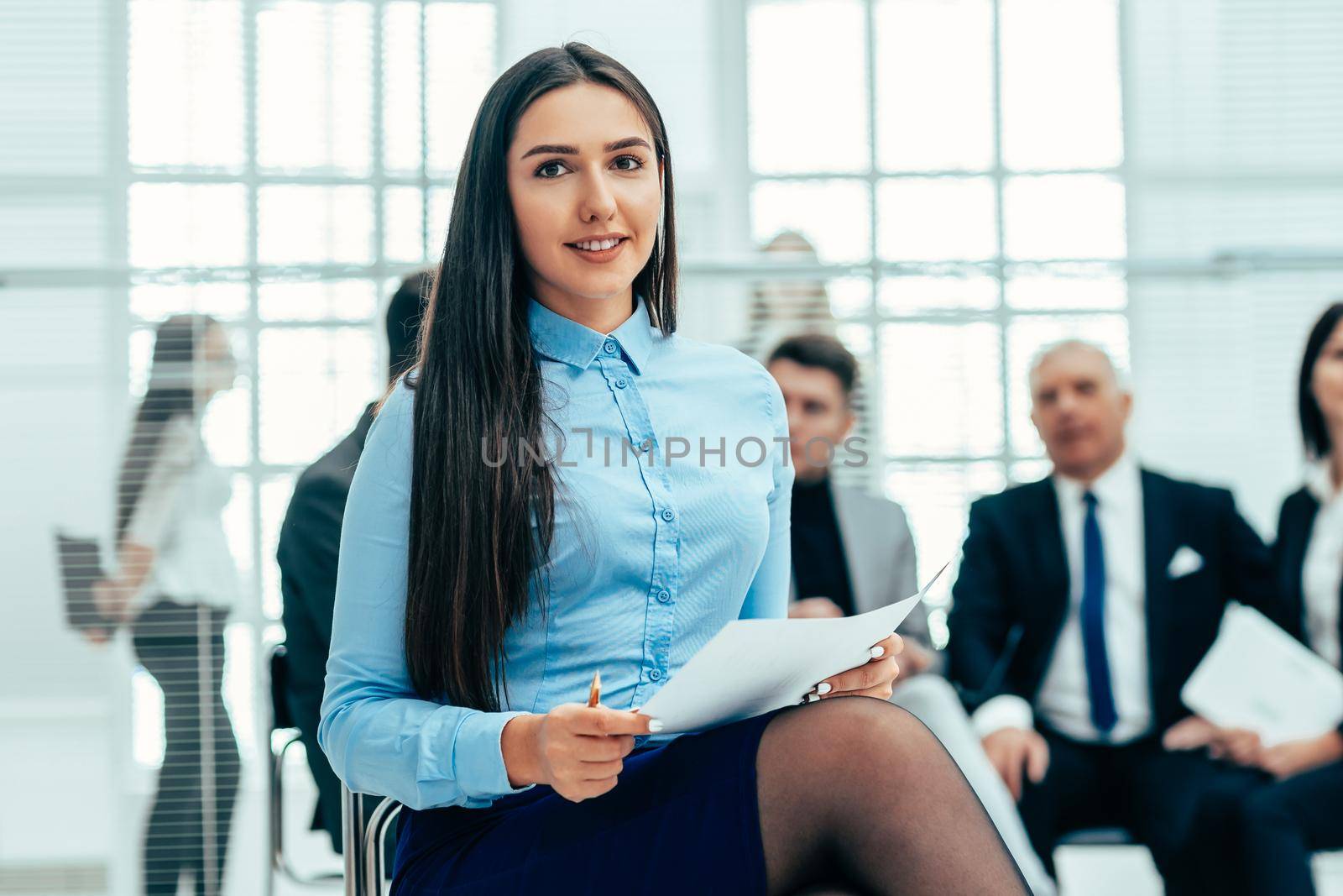 close up. female consultant against the background of a modern office. work with documents