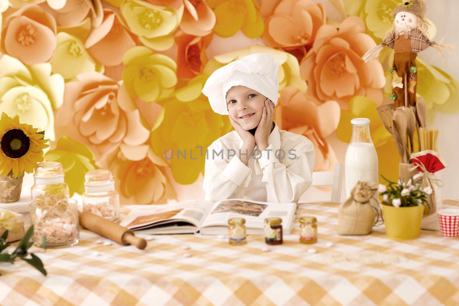 cute little baby is preparing tasty meals in the kitchen