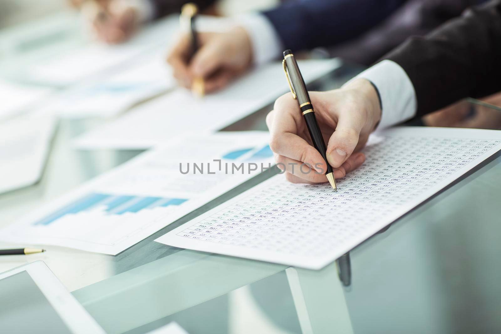 closeup: hands business team that works with financial schemes behind a Desk