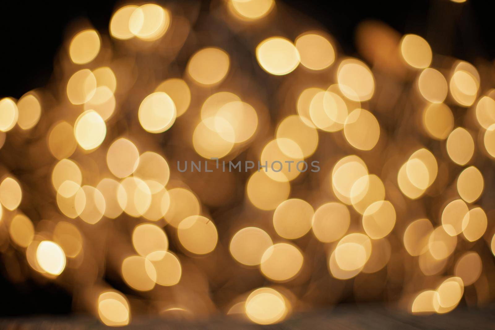 blurred golden lights on a black background . photo with a copy-space.