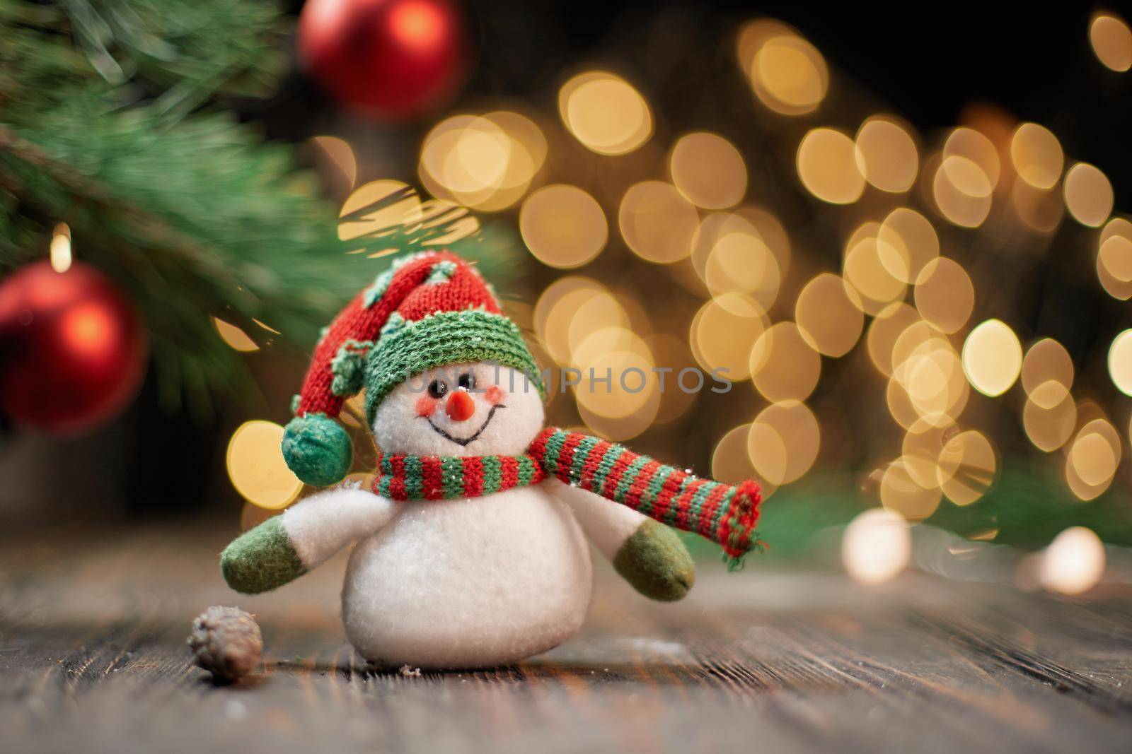 funny toy snowman on the background of Christmas lights. photo with a copy-space.