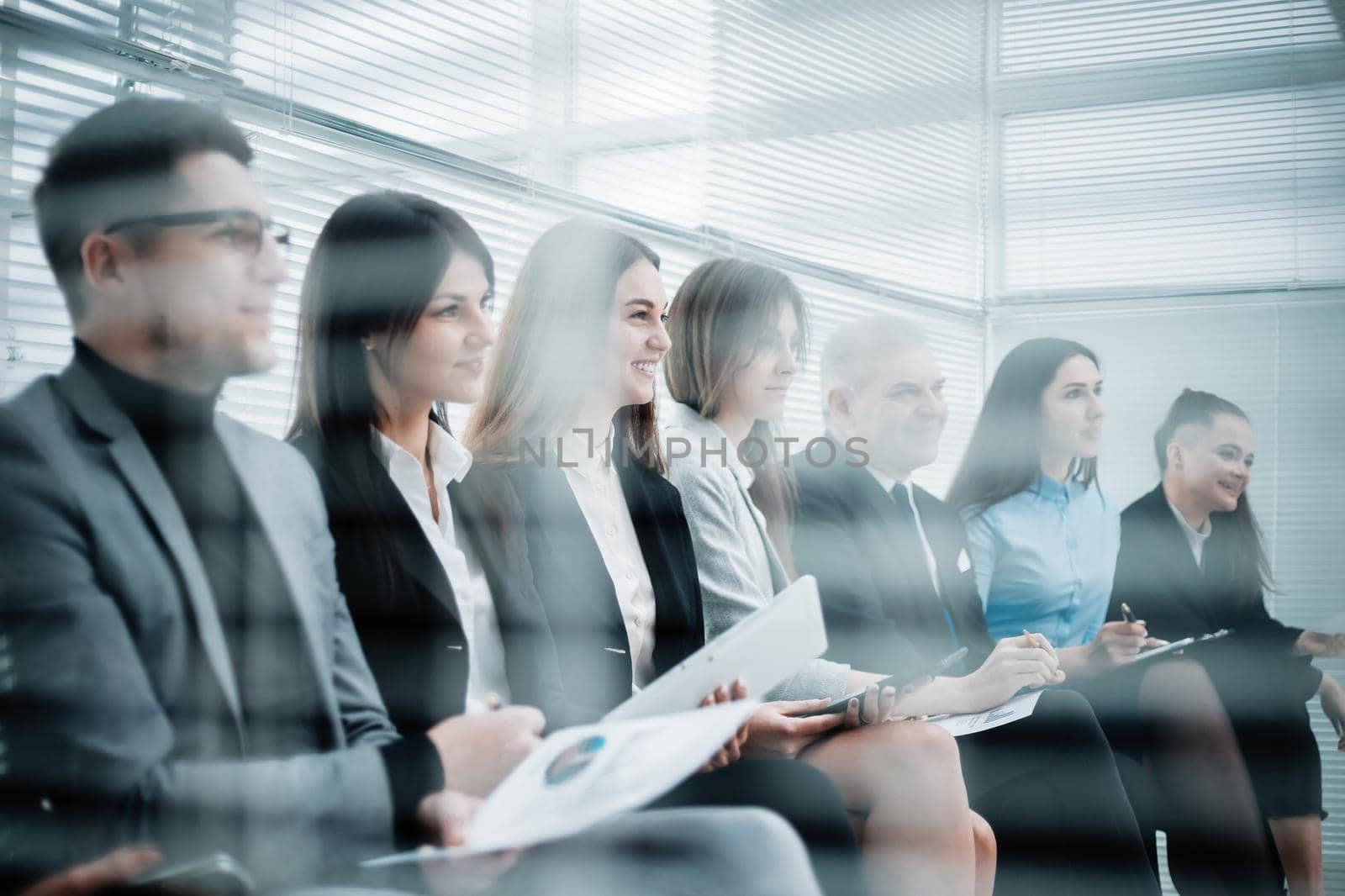 employees discussing financial data at a work meeting by SmartPhotoLab