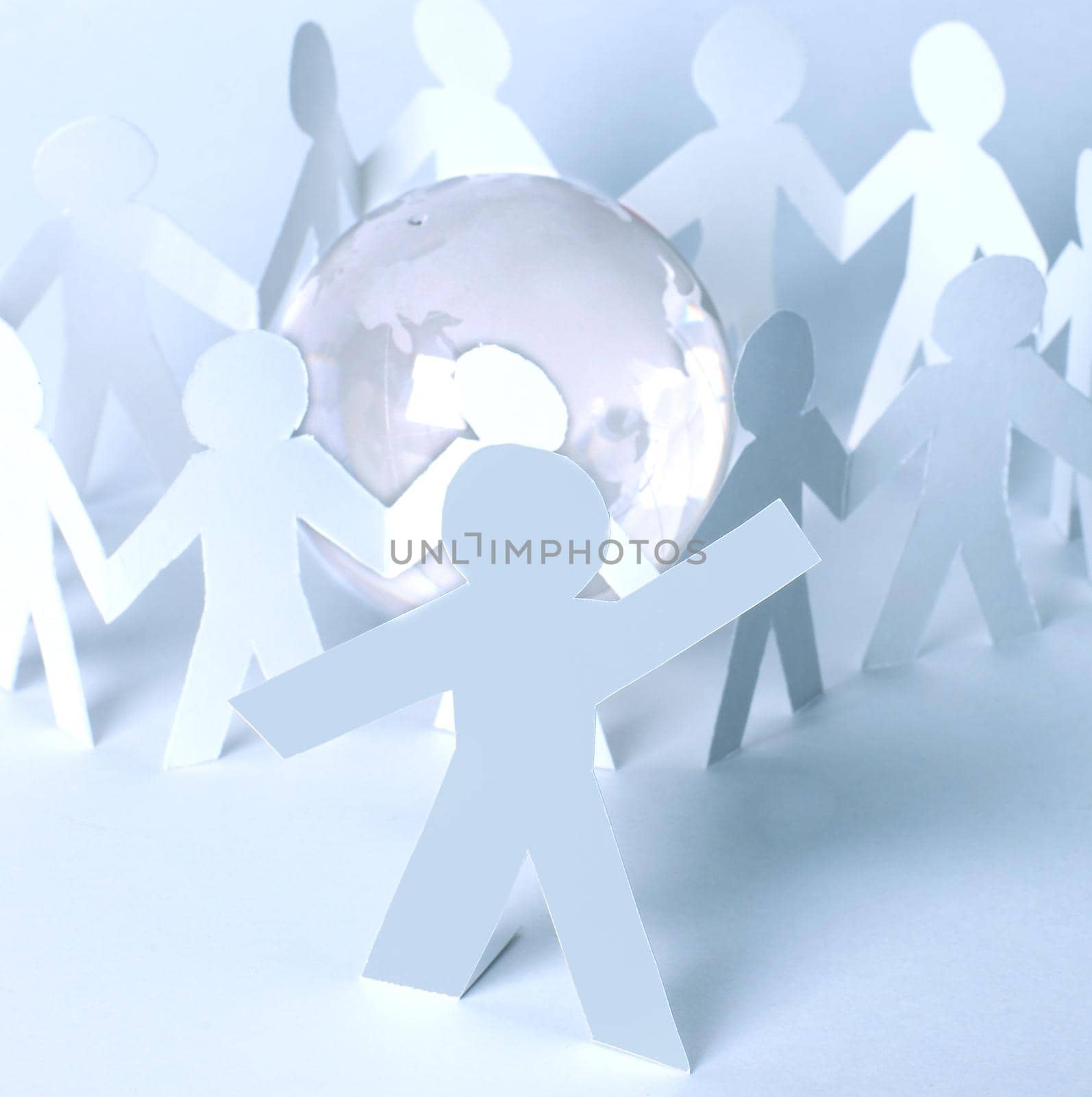 Paper man-leader against the background of paper people with glass globe by SmartPhotoLab