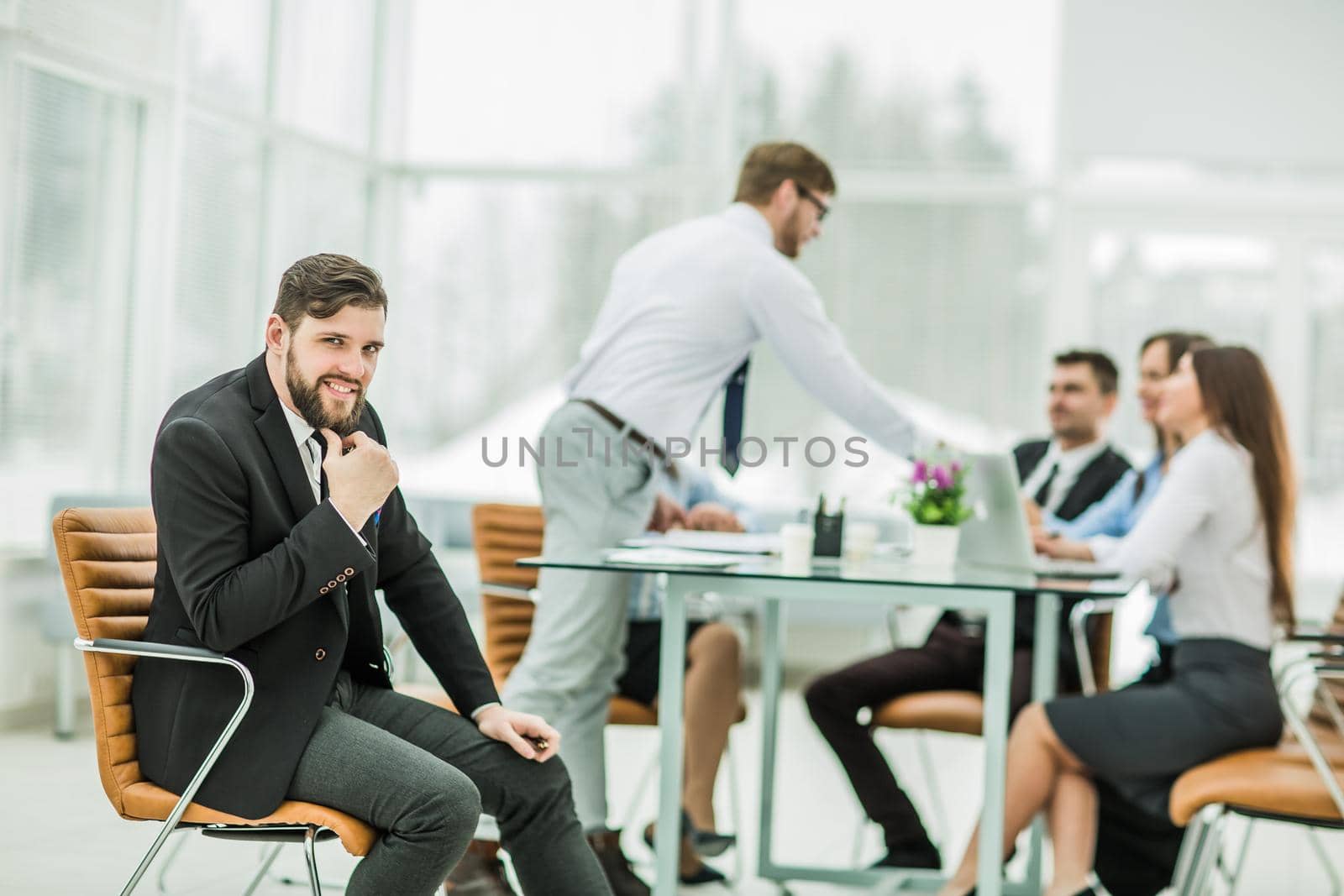 Manager on the background of business team working in office.the photo has a empty space for your text