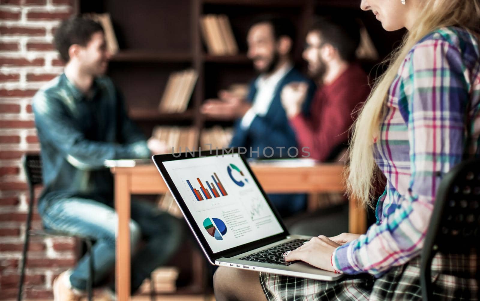accountant works with financial charts on the laptop in the office on the background of a successful business team