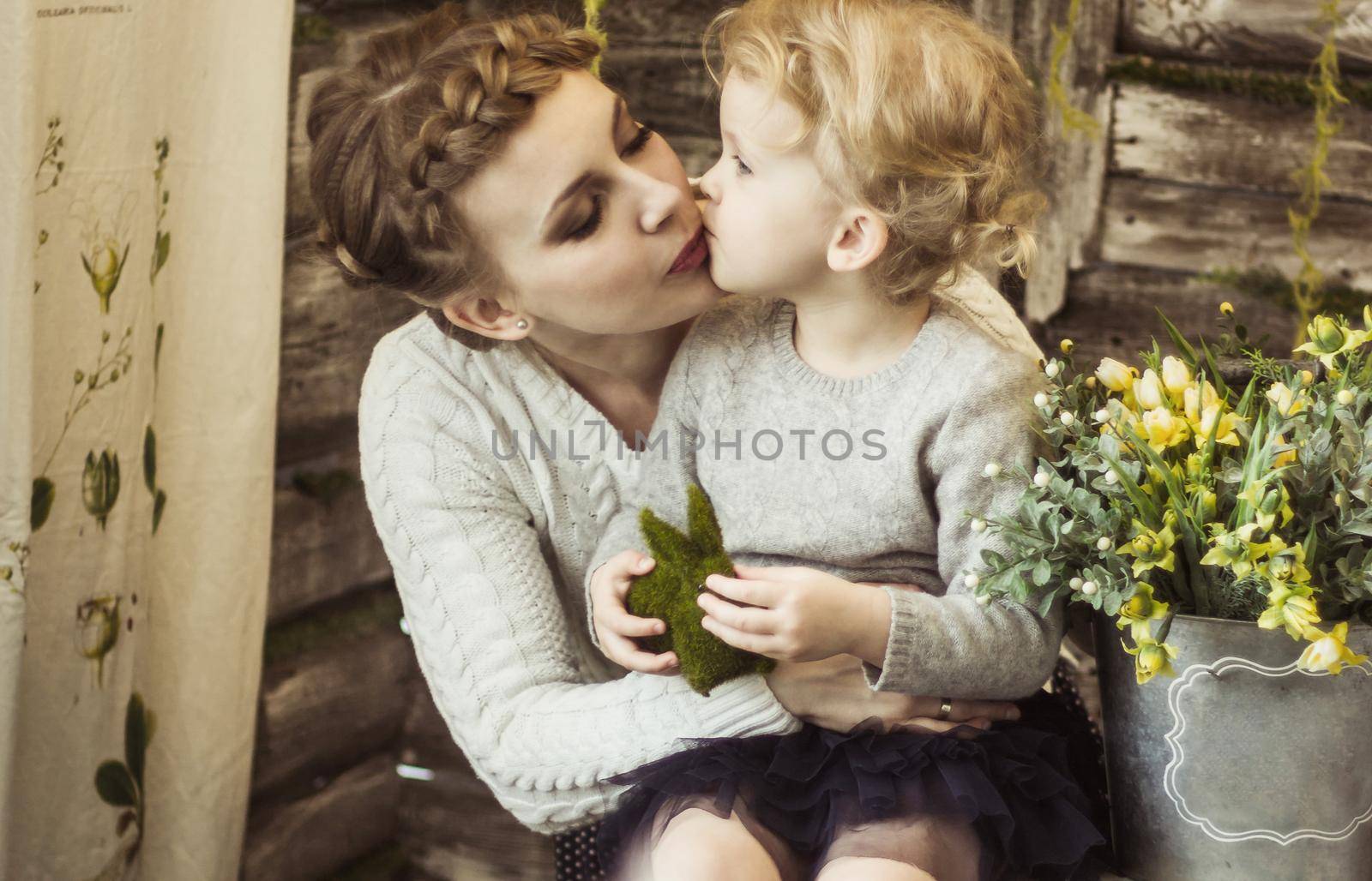 loving and caring mom, hugs and kisses his little daughter