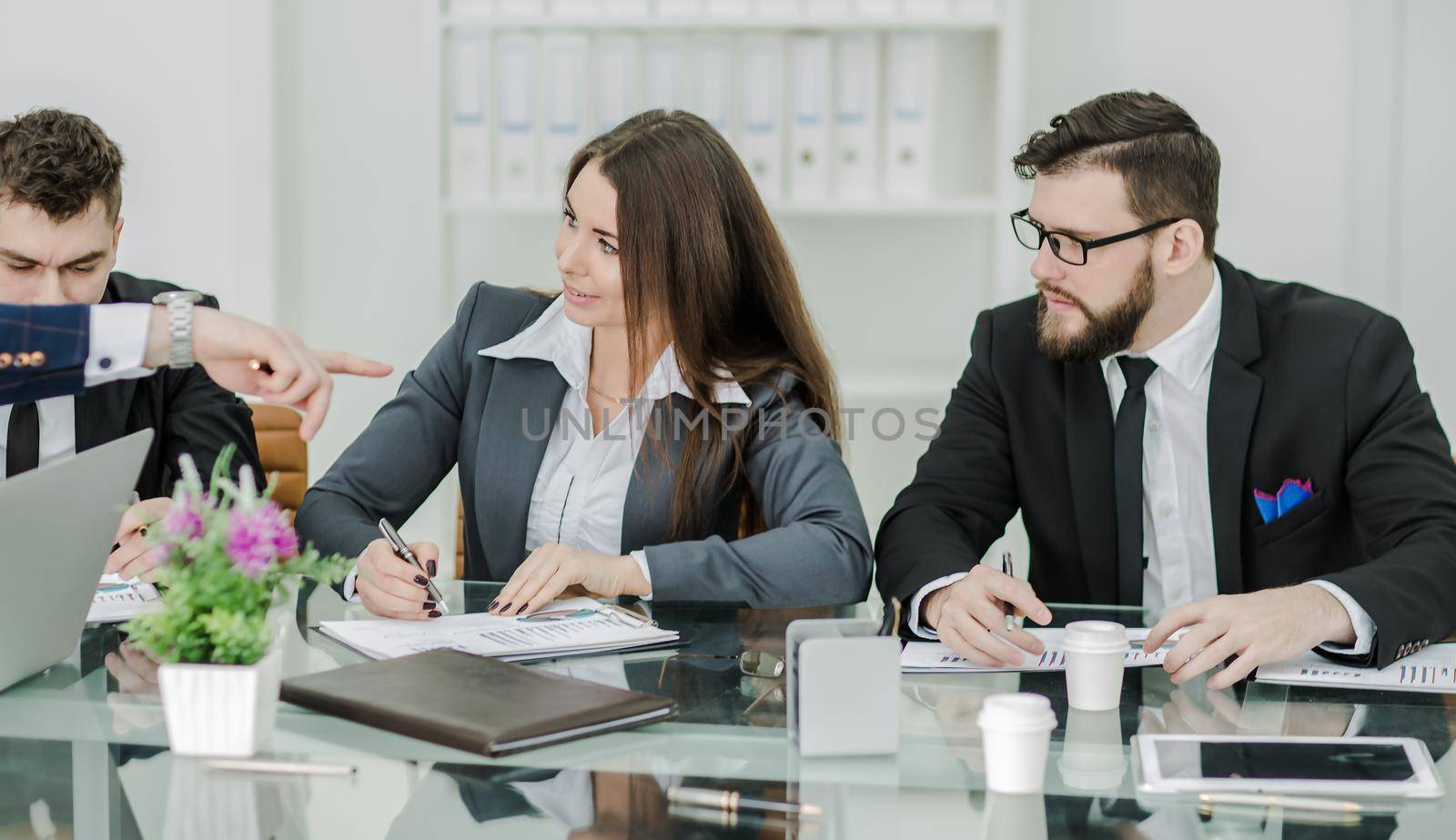 business team of professionals prepares a presentation of a new financial project.the photo has a empty space for your text
