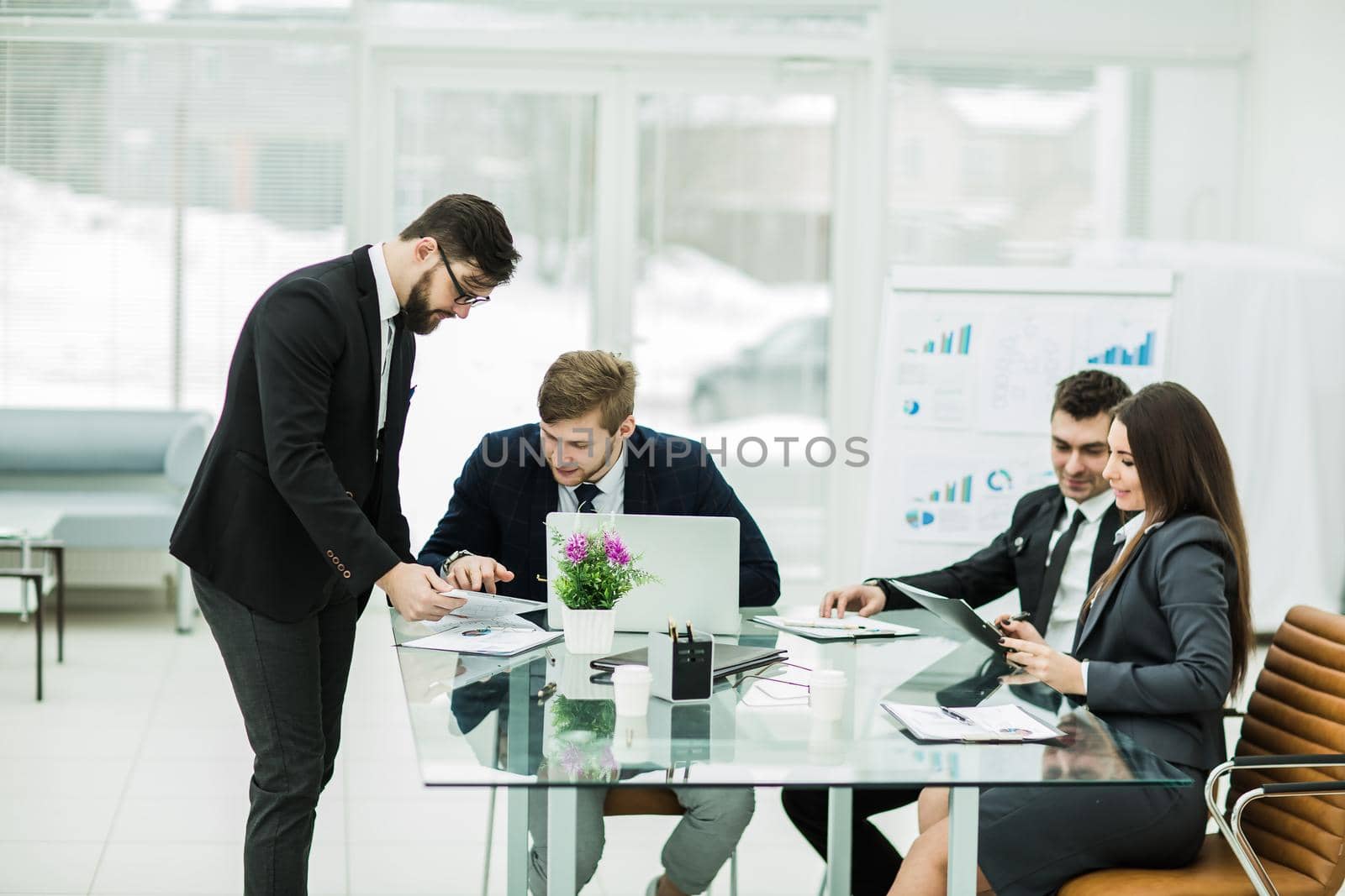 business partners discuss the profits before signing a new contract at the workplace in a modern office.the photo has a empty space for your text