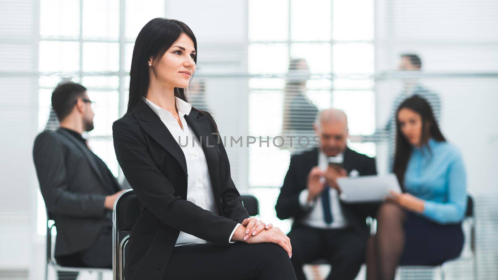 close up. confident young business woman sitting in a modern office