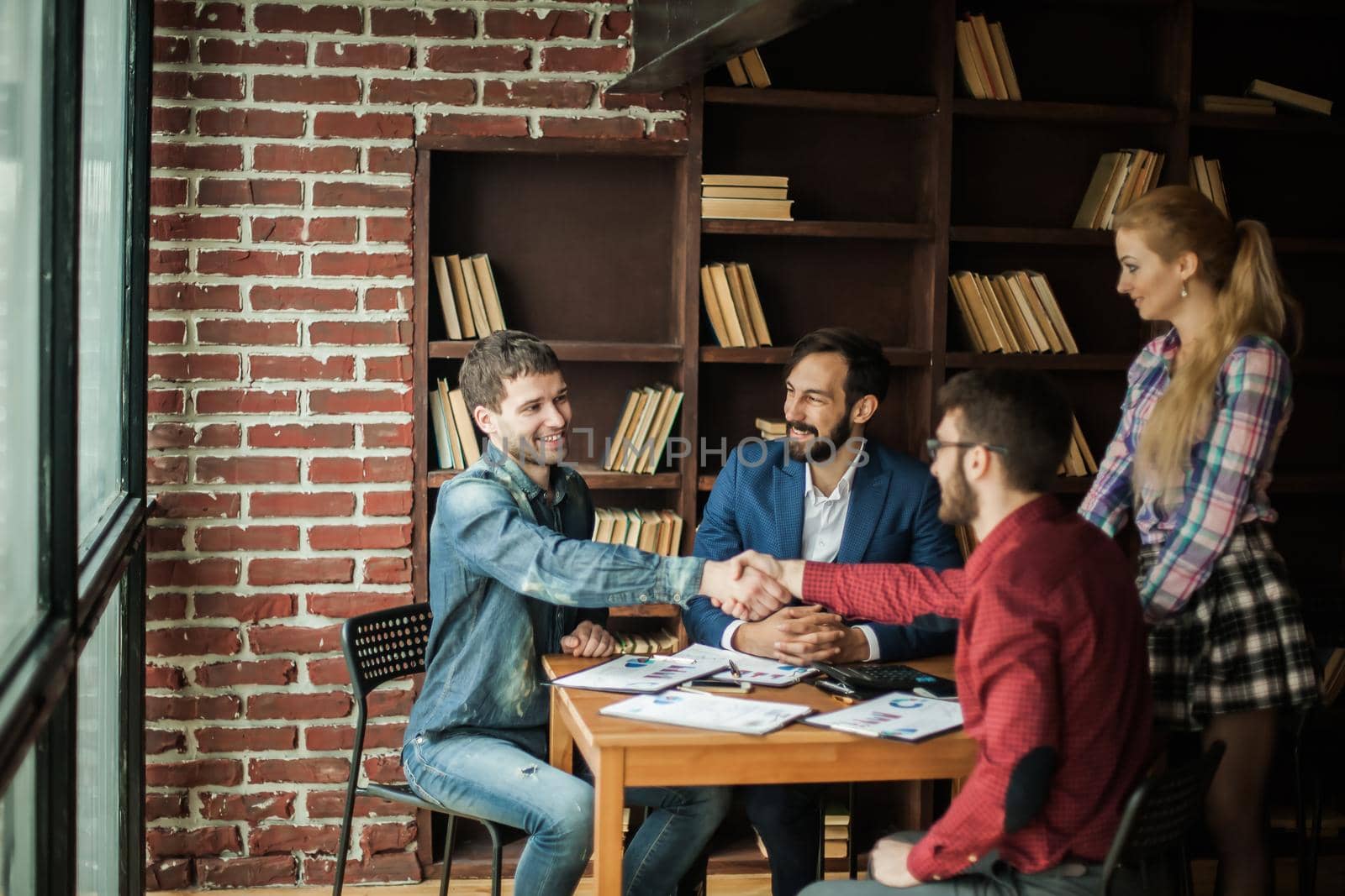 reliable business partners shake hands after discussing the contract for the work space in the office.the photo has a empty space for your text