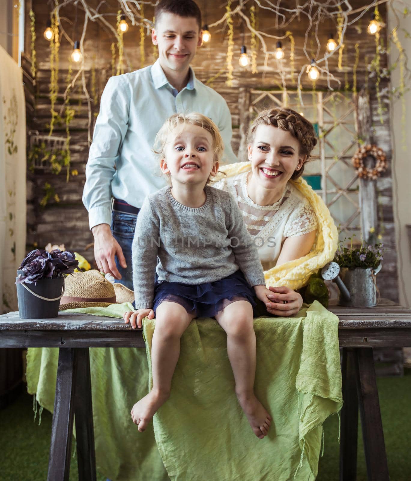 mother,father and their five year old daughter in the living room