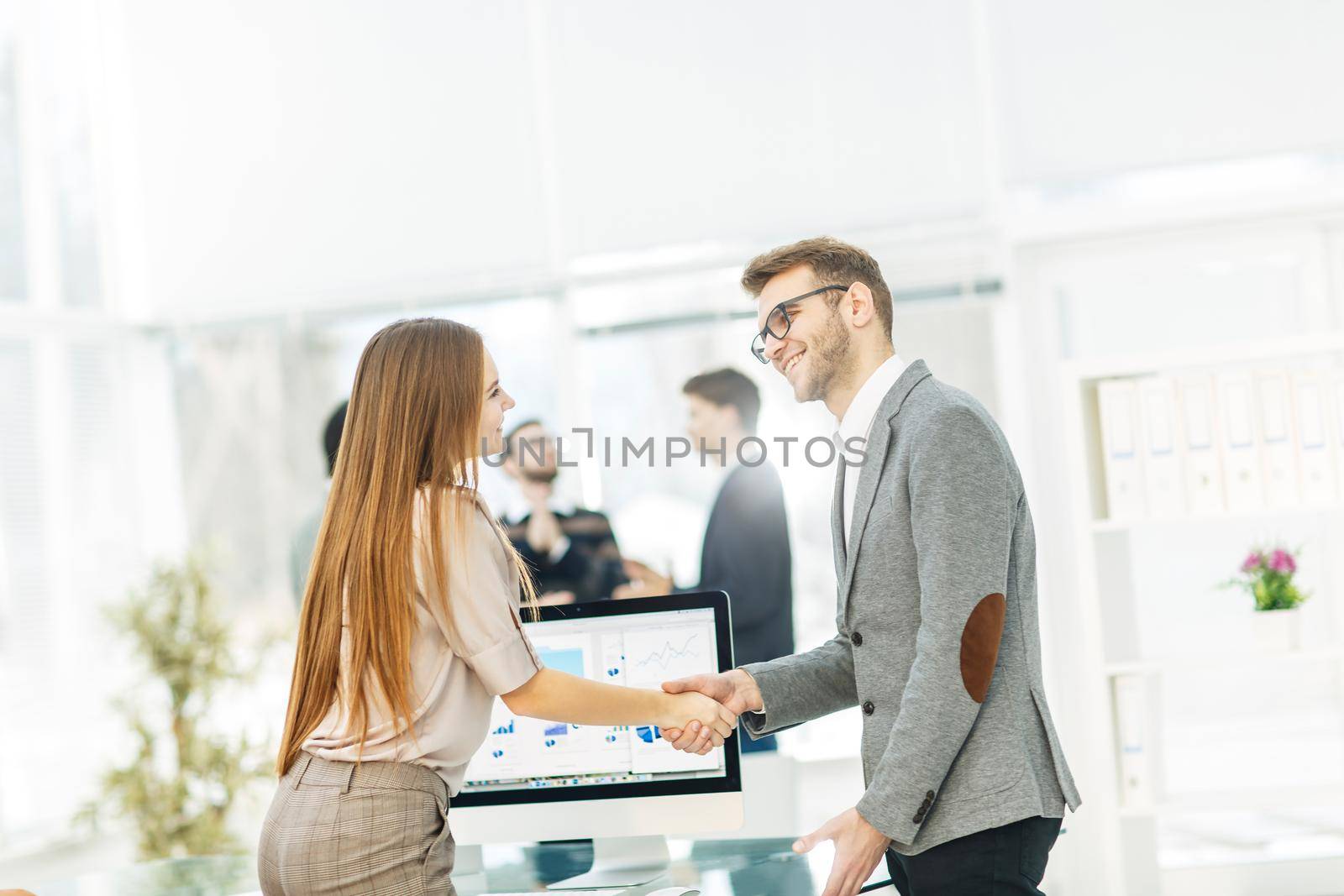 handshake between lawyer and client after reviewing the investment plan for development of the company.the photo has a empty space for your text.