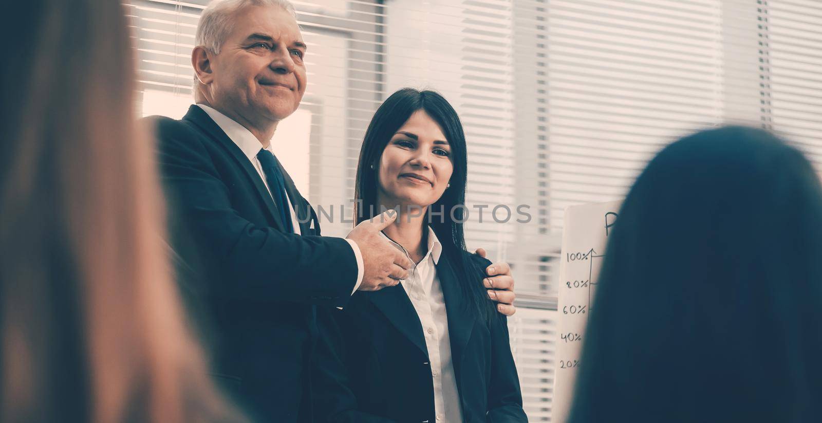 boss introducing a young employee during a meeting with the business team