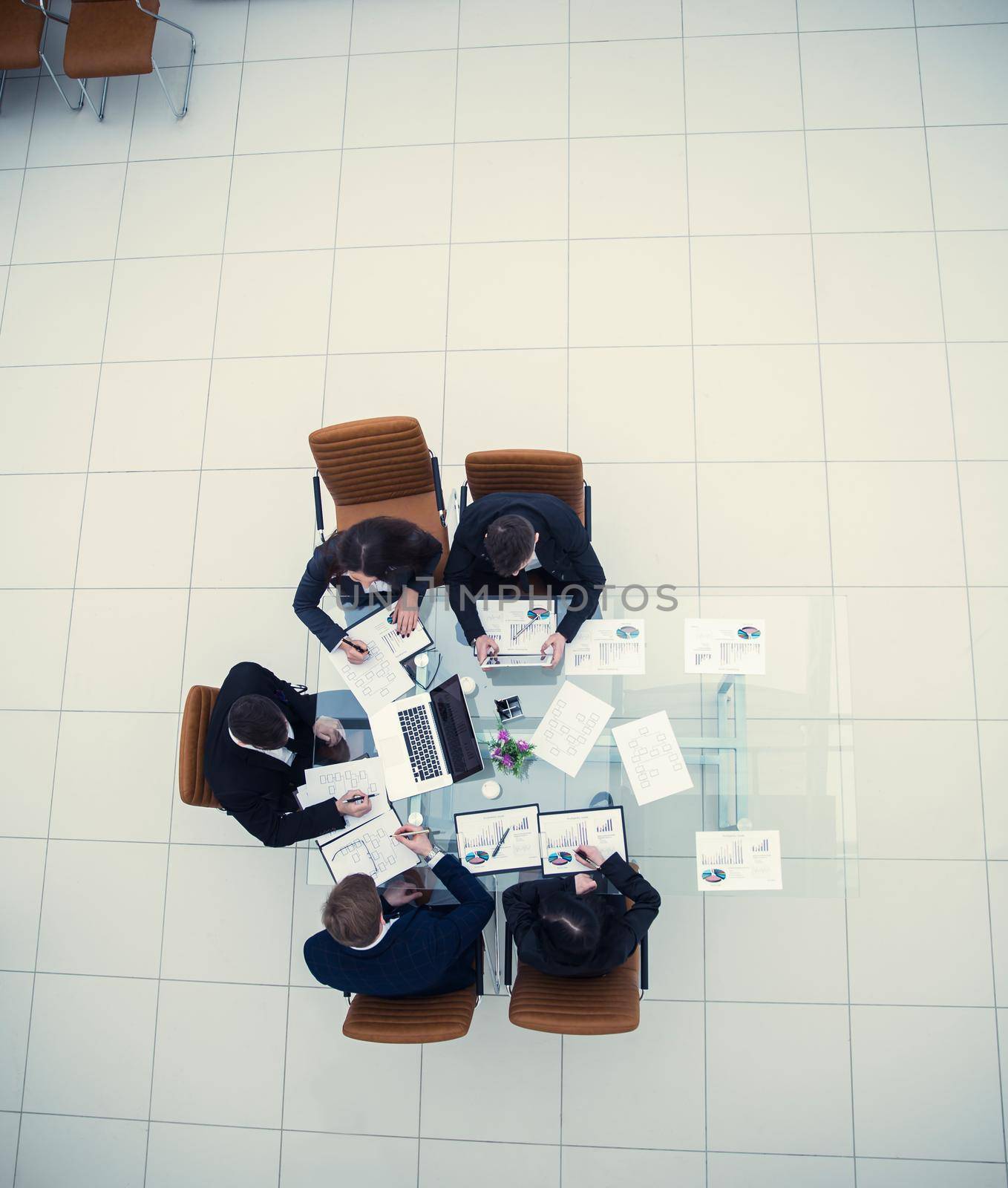 top view of successful business team discussing a new marketing schemes in the workplace in the office.the photo is a blank space for your text