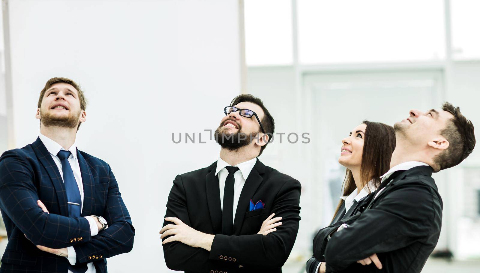 successful business team standing with folded hands in front of him .the photo has a empty space for your text