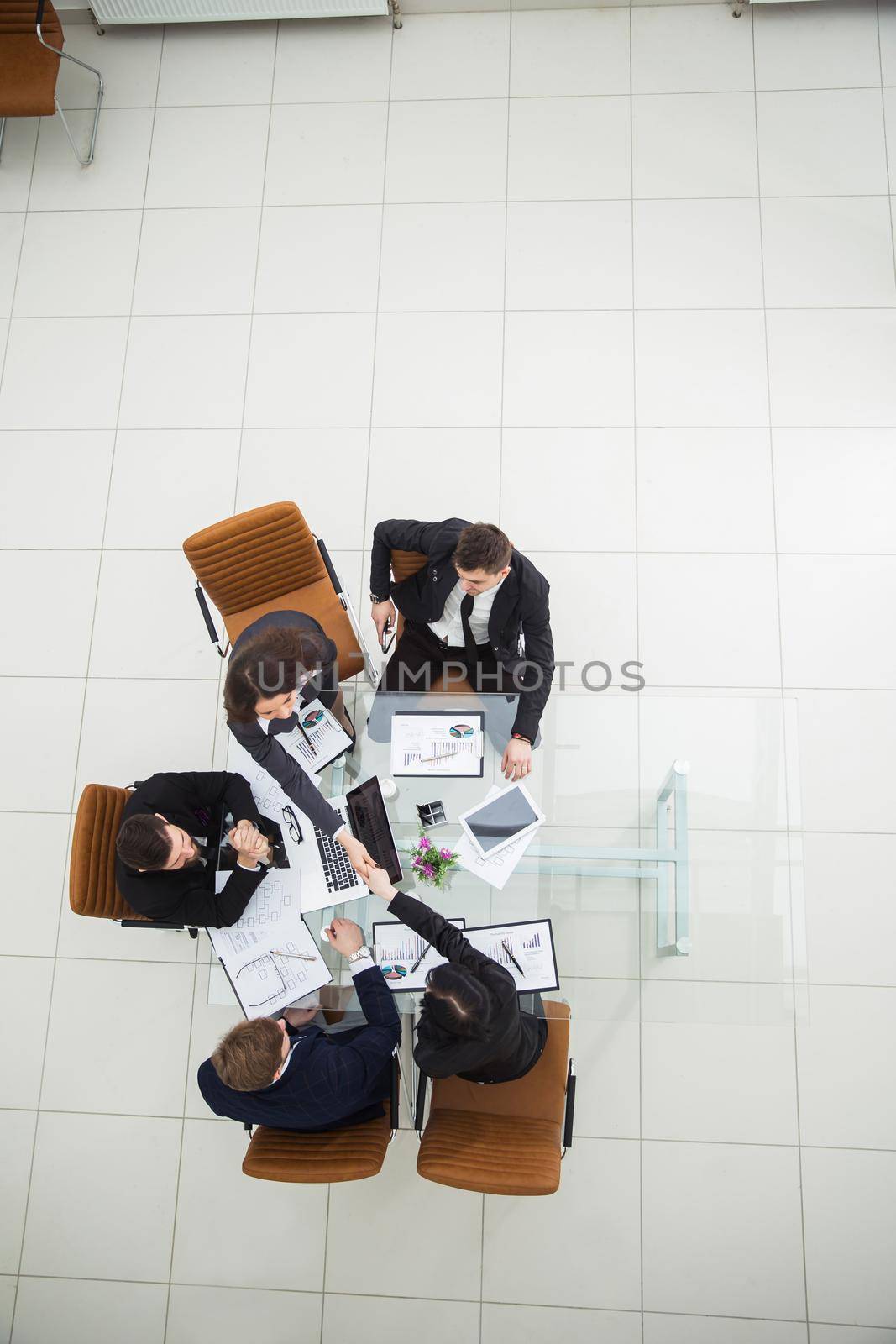 top view of business partners shaking hands after a discussion of the new fiscal Treaty.the photo is a blank space for your text
