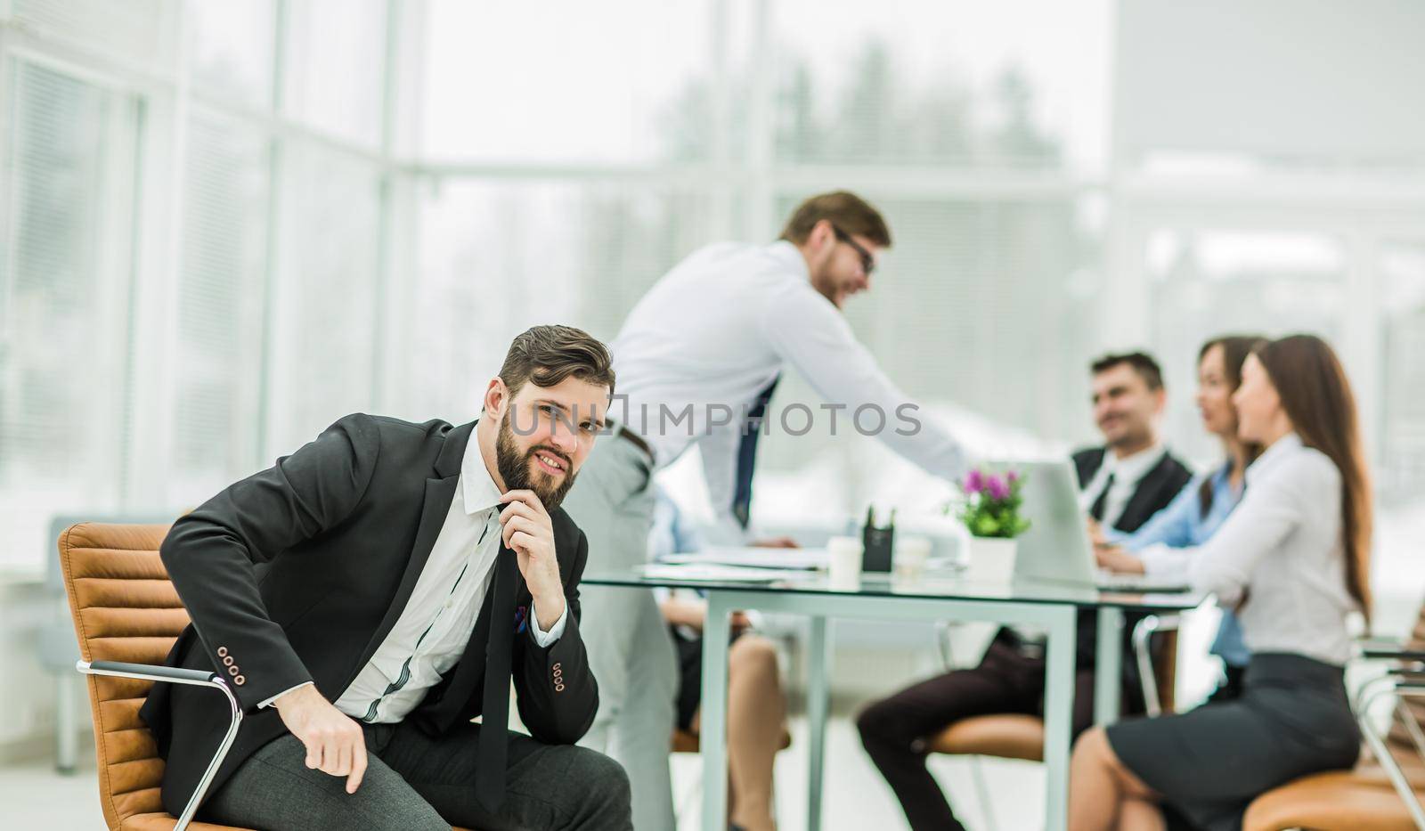 Manager on the background of business team working in office.the photo has a empty space for your text