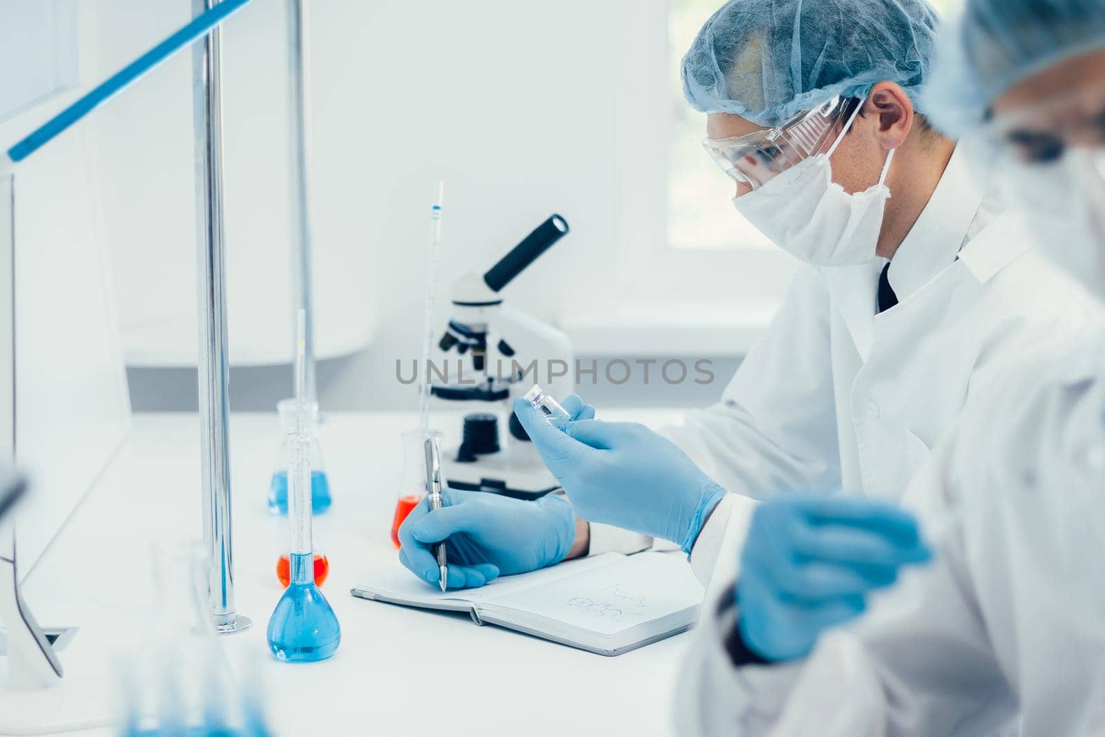 close up. group of scientists testing the results of a new vaccine . photo with a copy-spac