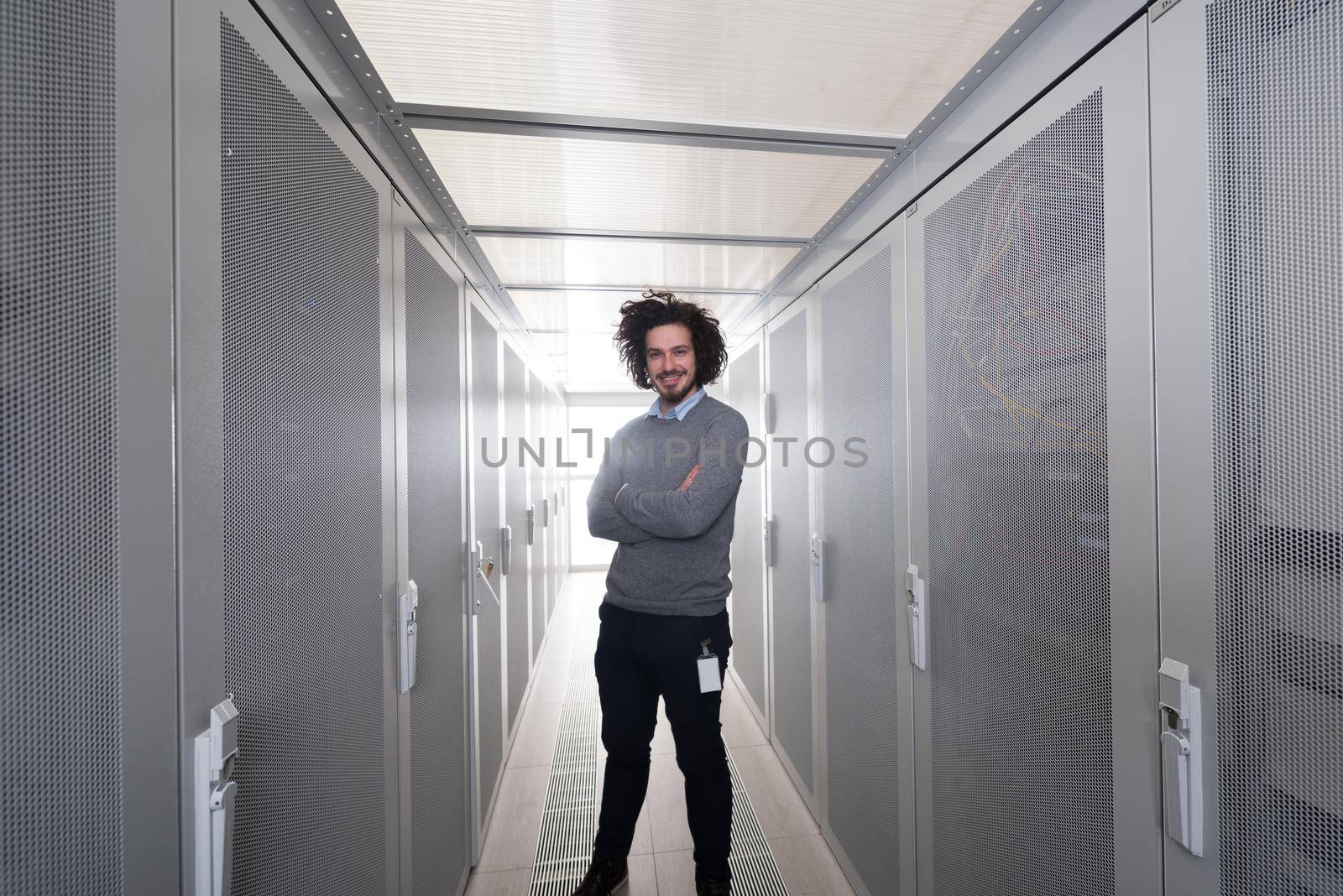 portrait of young handsome IT engeneer in datacenter server room