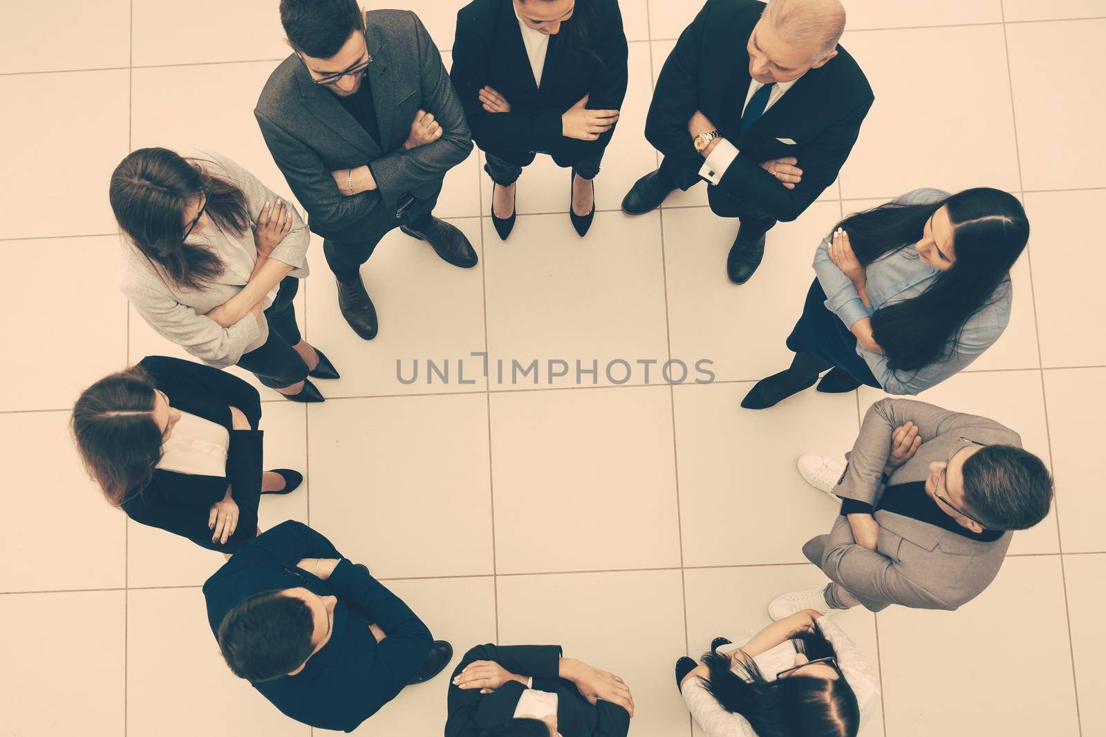 top view. group of business people standing in a circle. the concept of team building