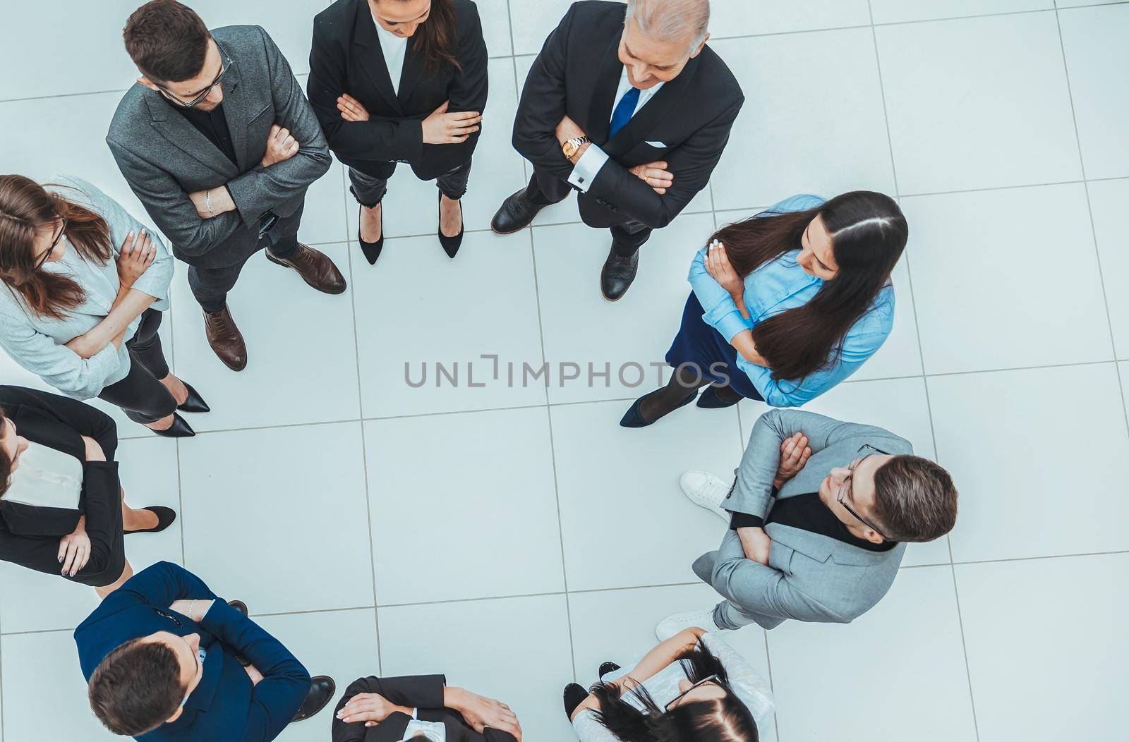 top view. group of business people standing in a circle. the concept of team building