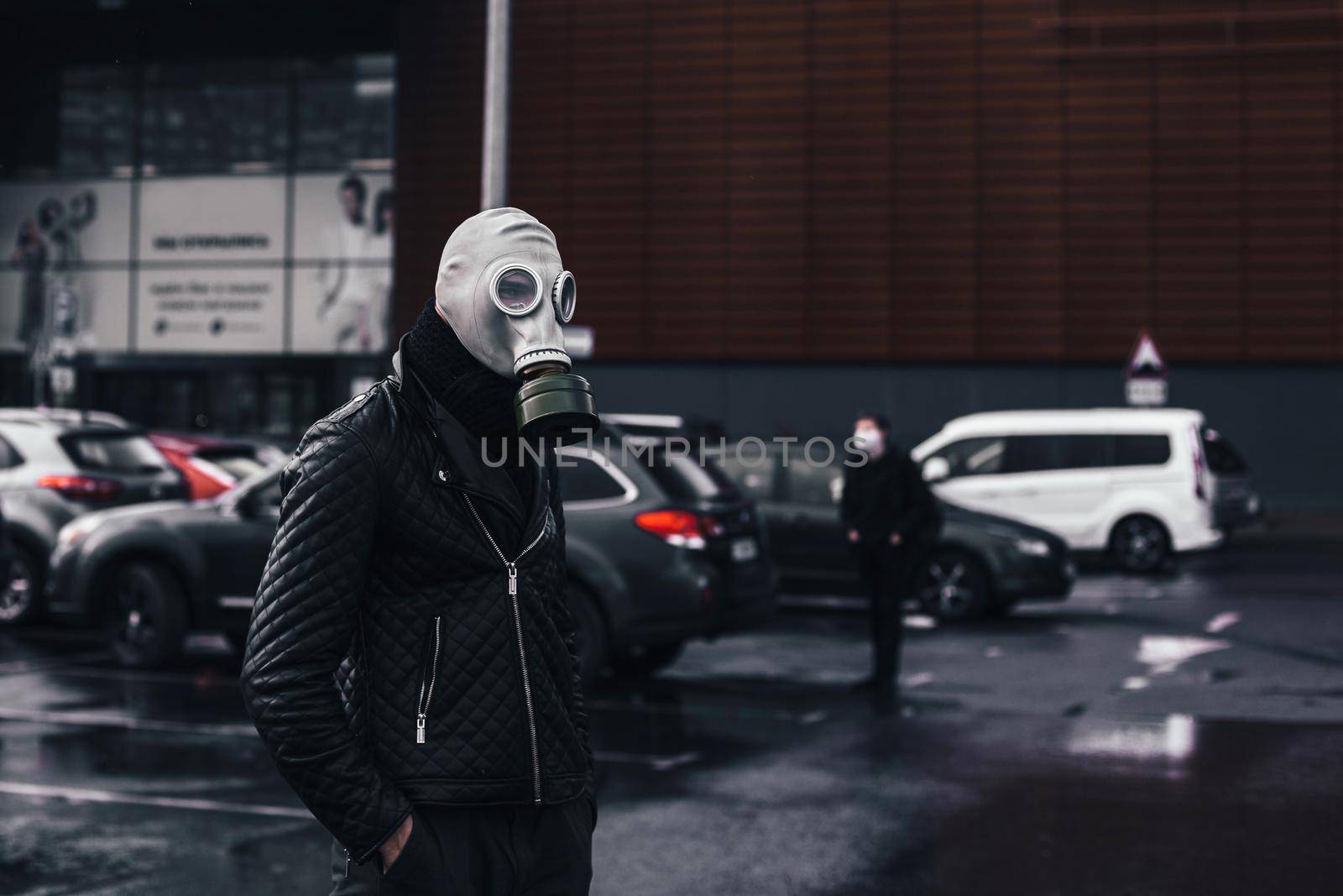 man in a gas mask standing in a city Parking lot by SmartPhotoLab