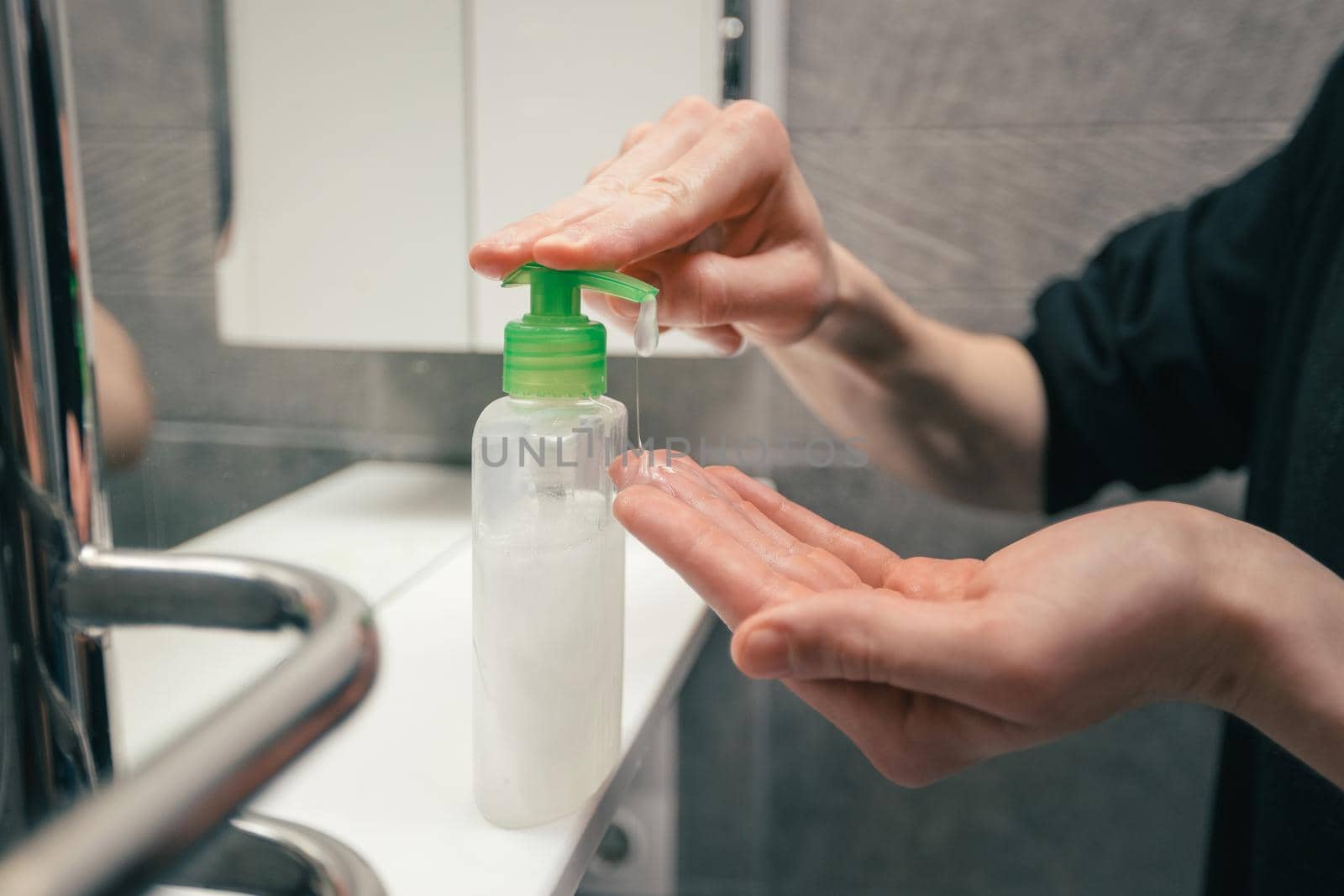 close up. man using a bactericidal hand soap. by SmartPhotoLab