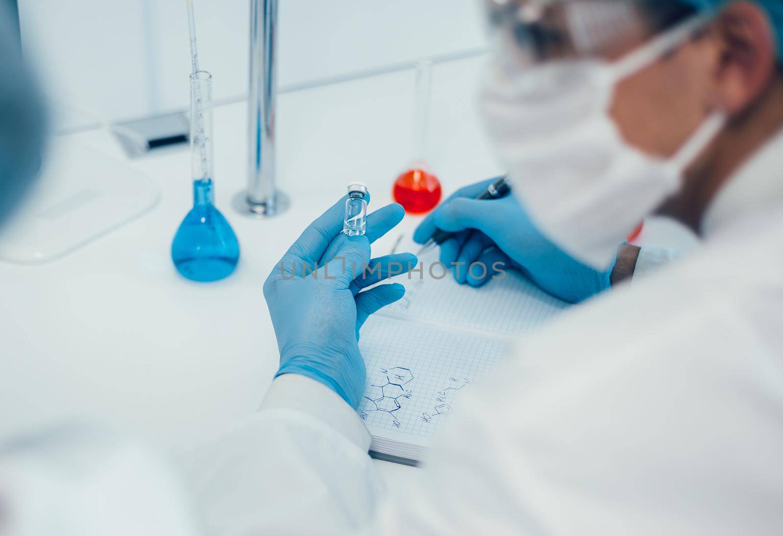 close up. a scientist writing down the formula for a new drug . photo with a copy-space.