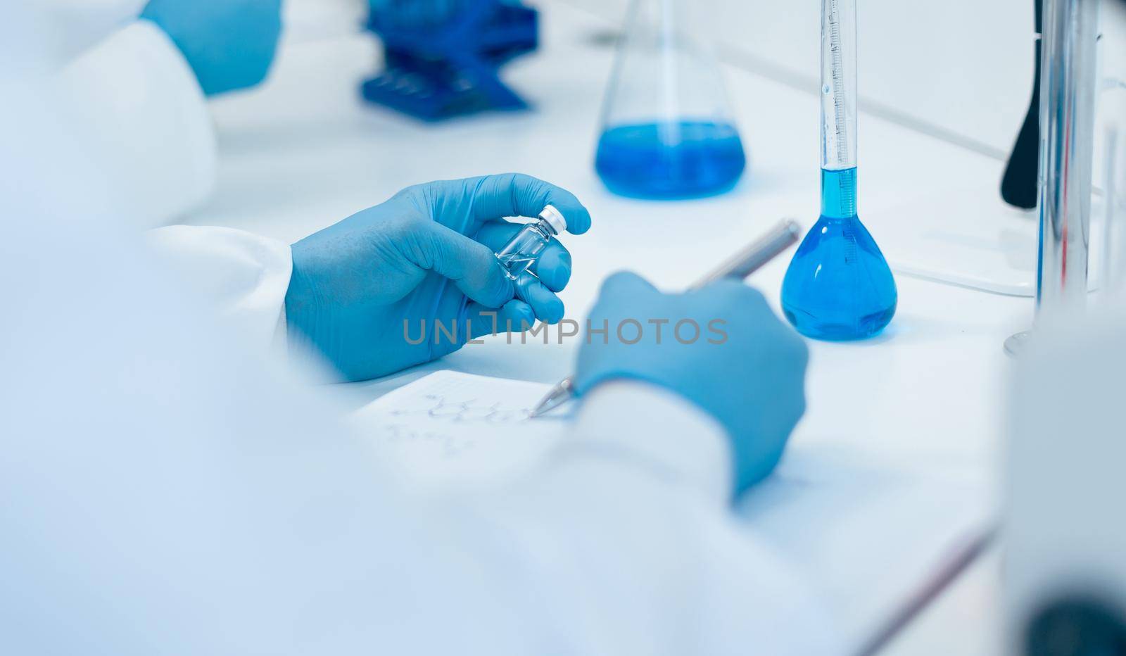 rear view. scientist recording the results of investigations in a laboratory journal . photo with a copy-space.