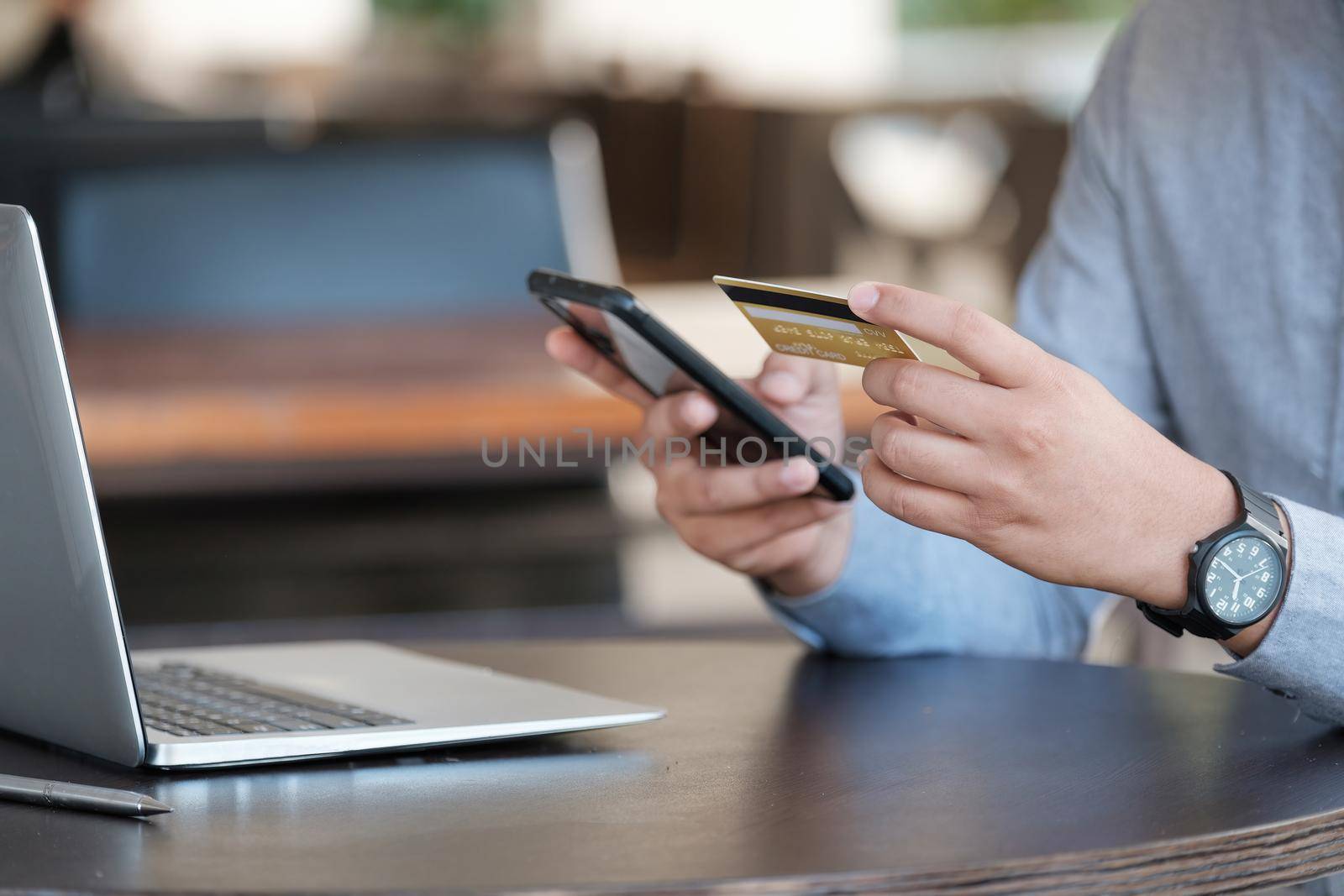 Online payment, Close up man's hands holding smartphone and using credit card for online shopping by nateemee