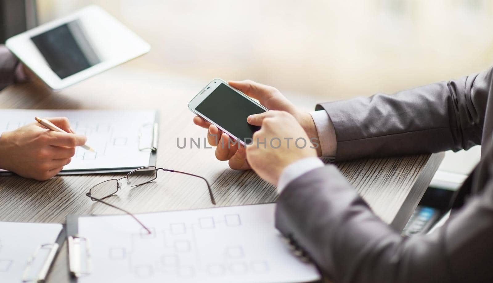 Business team working in a scheme business using the tablet and smartphone by SmartPhotoLab