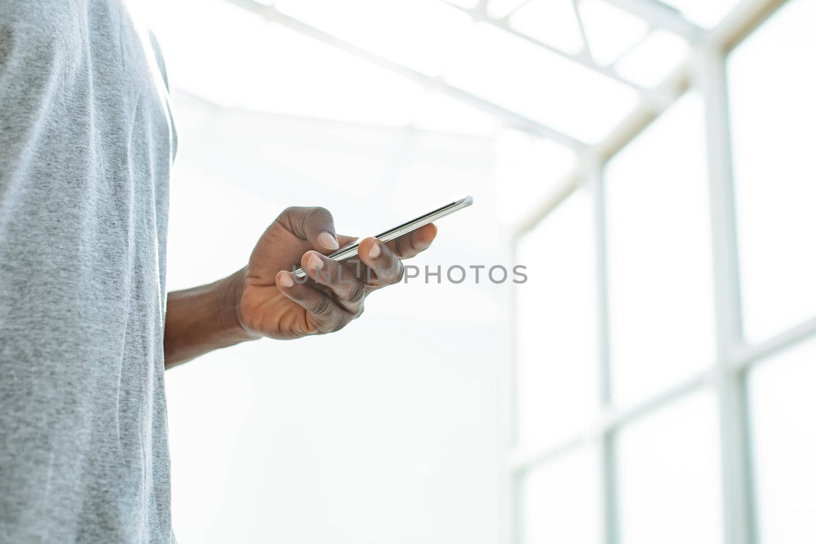 close up. young man looking at the screen of his smartphone. by SmartPhotoLab