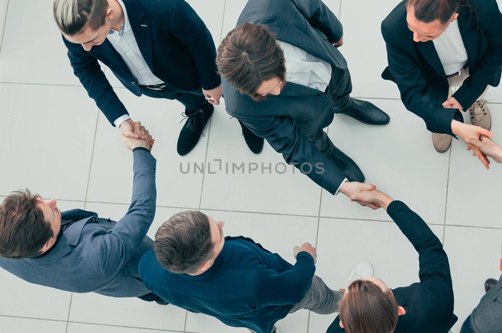 representatives of business teams greeting each other with a handshake. by SmartPhotoLab
