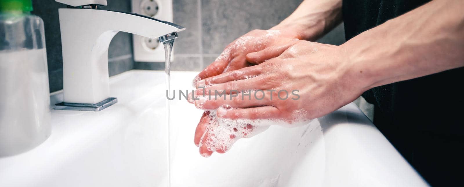 close up. soap suds on the hands of a young man . by SmartPhotoLab