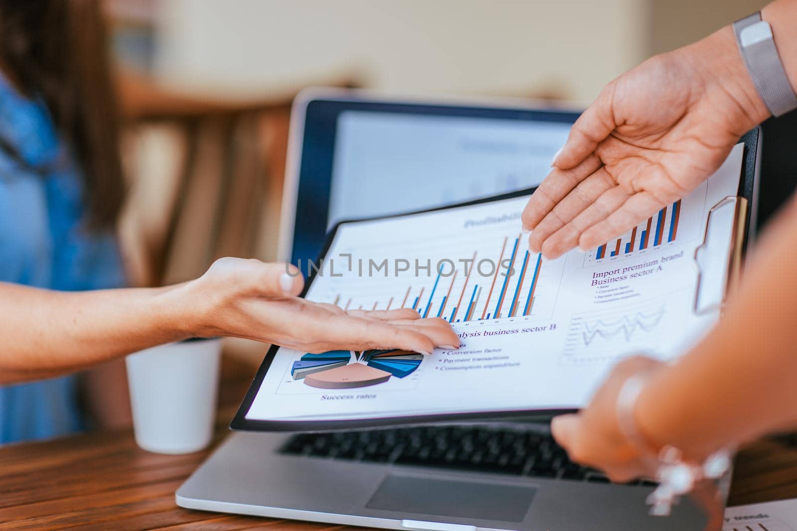 close up. employees discussing financial data near the desktop. people and technology.