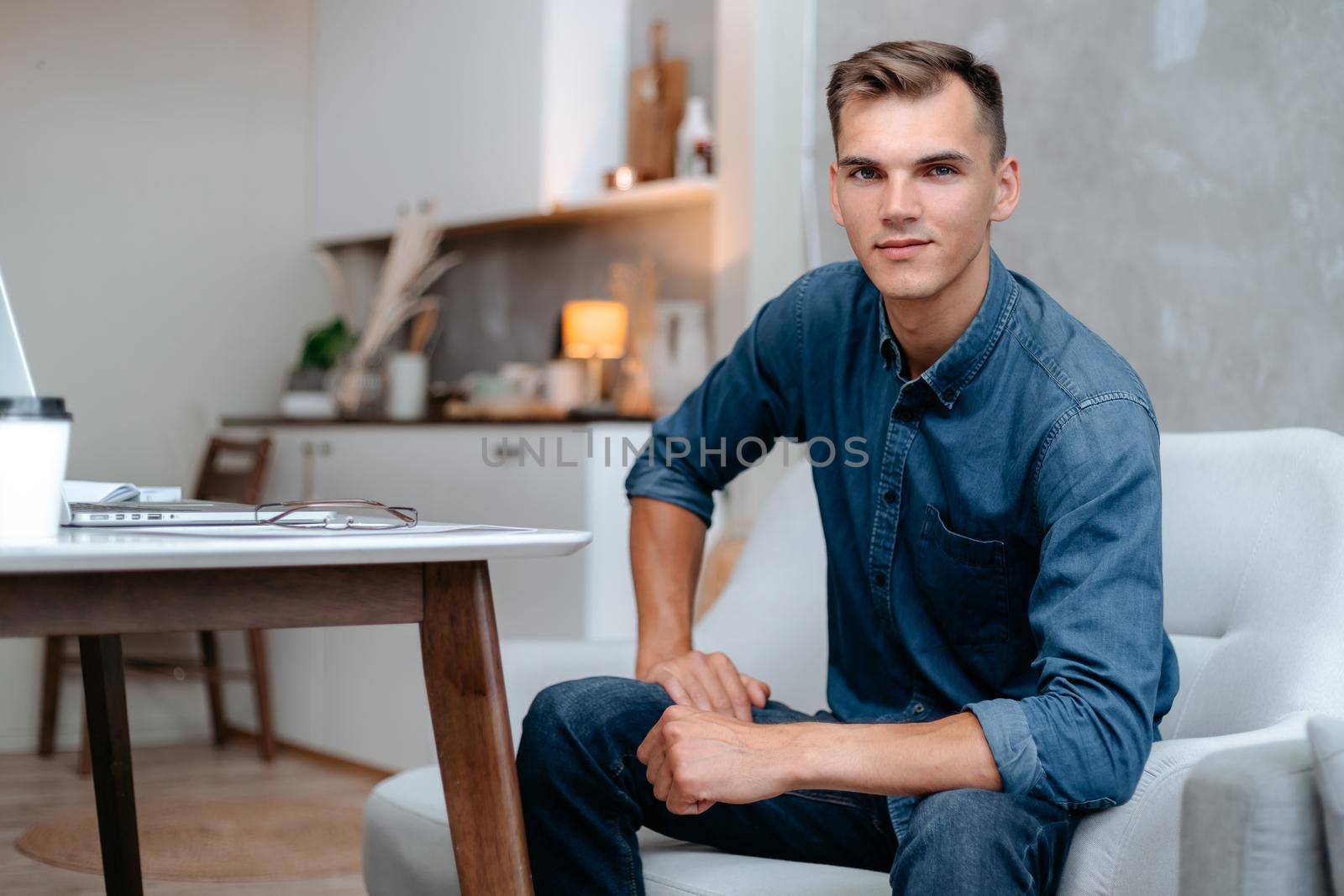 young man sitting in the home office. by SmartPhotoLab