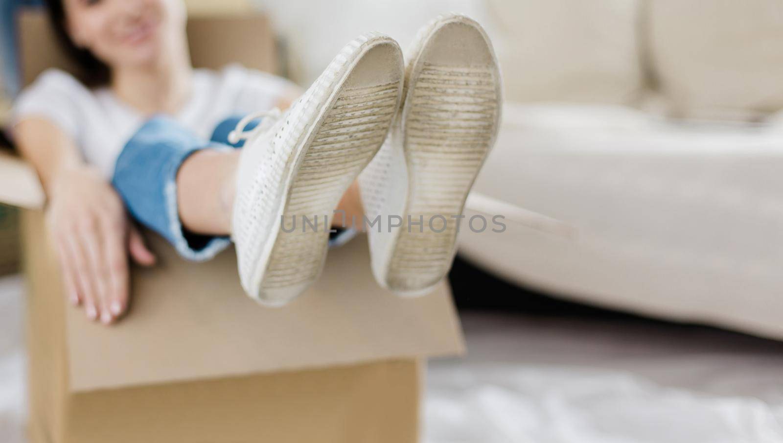 young couple unpacking boxes in new apartment by SmartPhotoLab