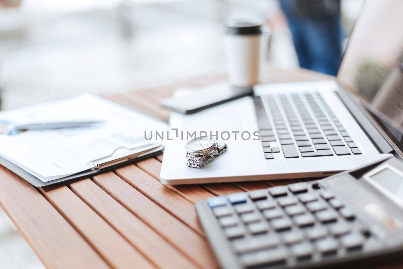 close up.image of a laptop and calculator on a table in a cafe . photo with a copy-space.