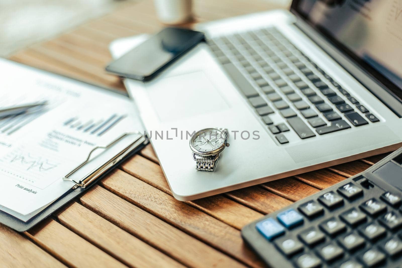 close up. image of a laptop and calculator on a table in a cafe. by SmartPhotoLab