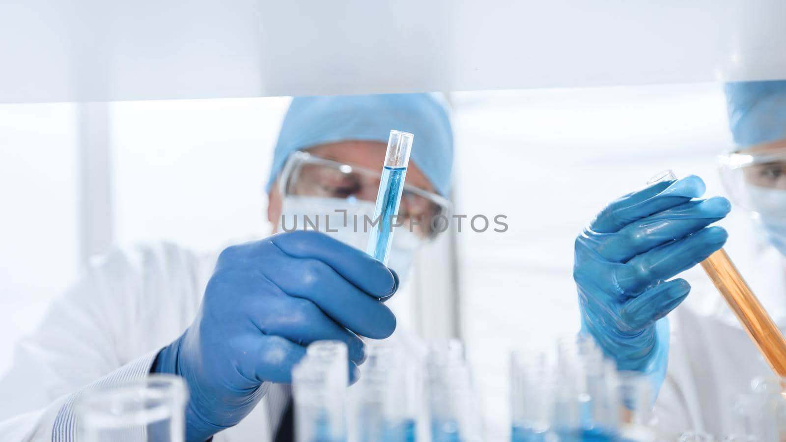 close up. scientists with test tubes in a biochemical laboratory . by SmartPhotoLab