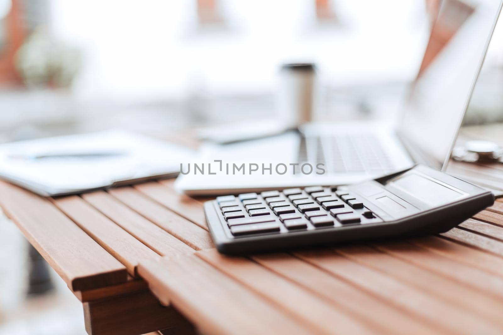 close up. calculator and laptop on a wooden table . photo with a copy-space.