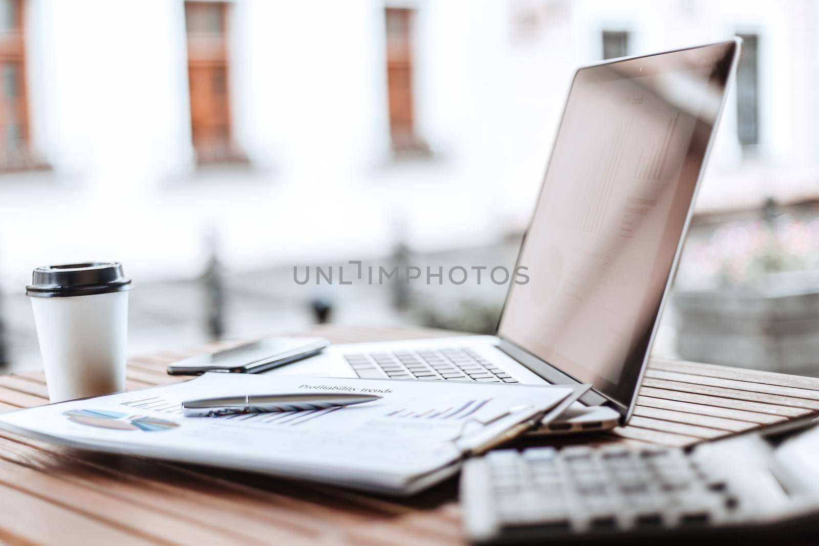 close up. table with financial charts on the terrace in the cafe by SmartPhotoLab