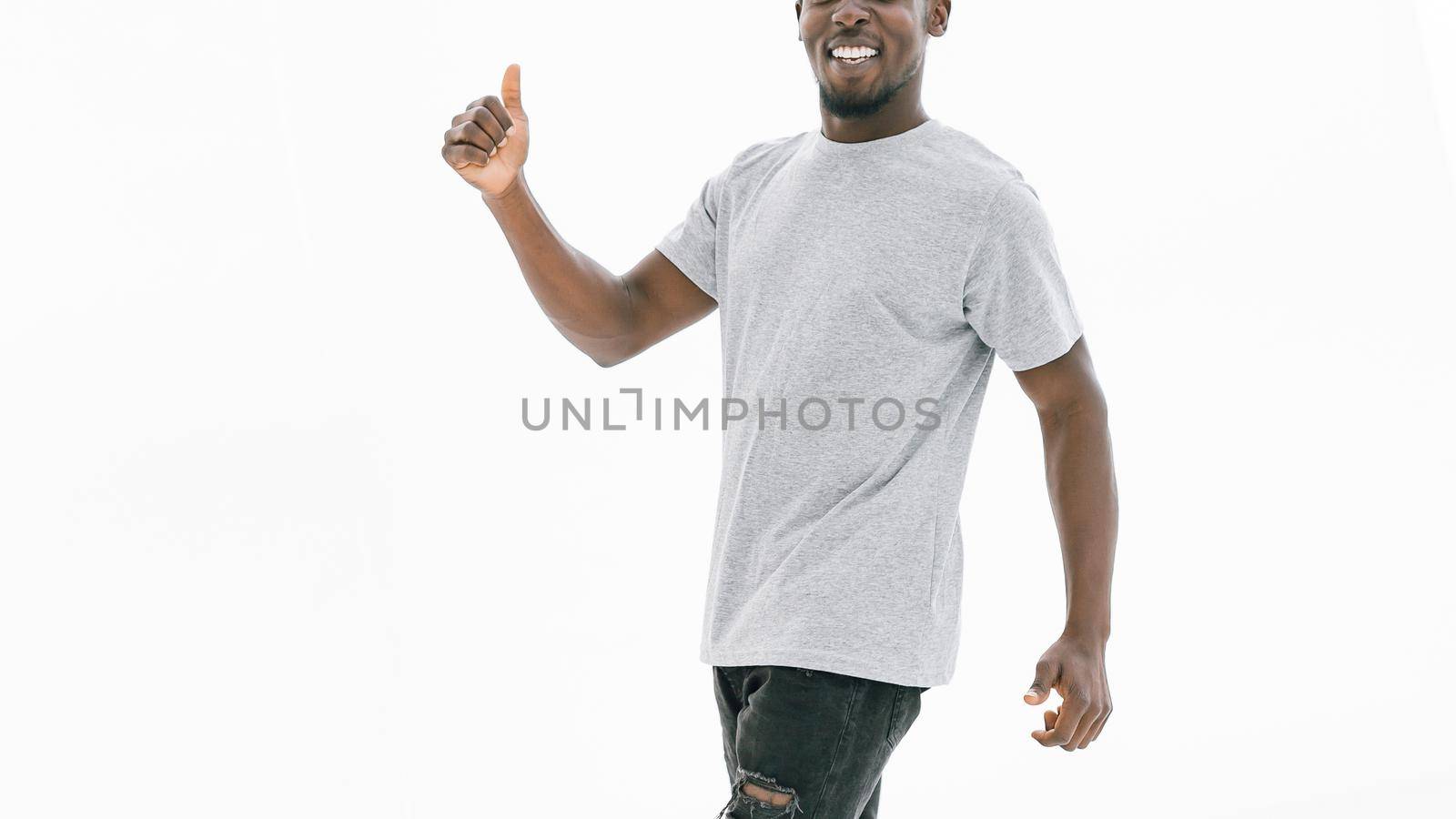 side view. smiling handsome guy showing thumbs up. isolated on white background